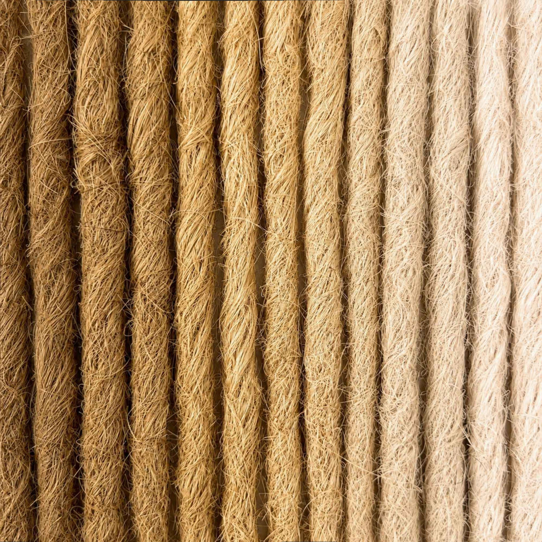 Handcrafted human hair Loc Extensions in the Blonde Color Family featuring warm blonde, beige, and light natural shades. 