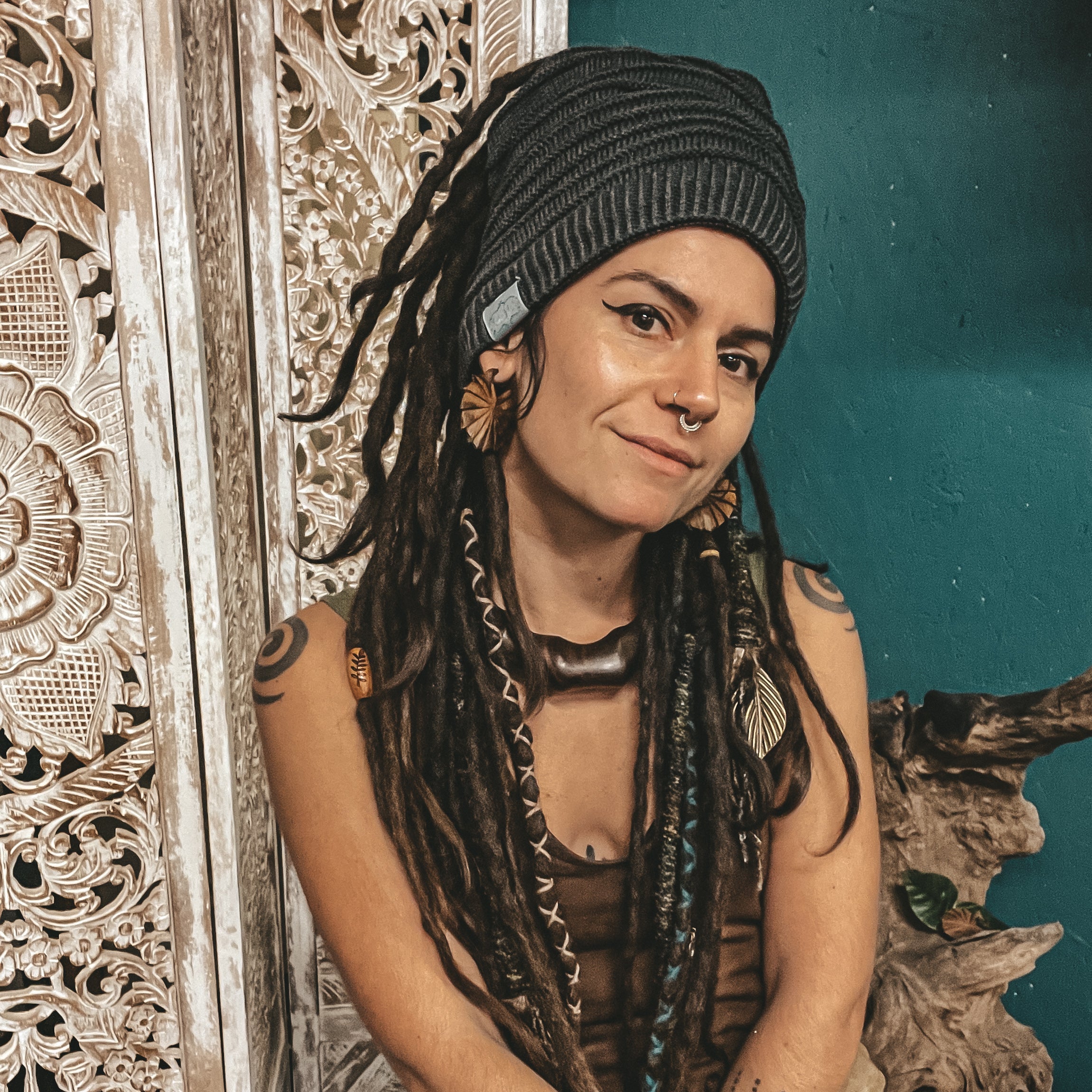 Person wearing a grey CrafterElena Simple Stripes beanie with locs