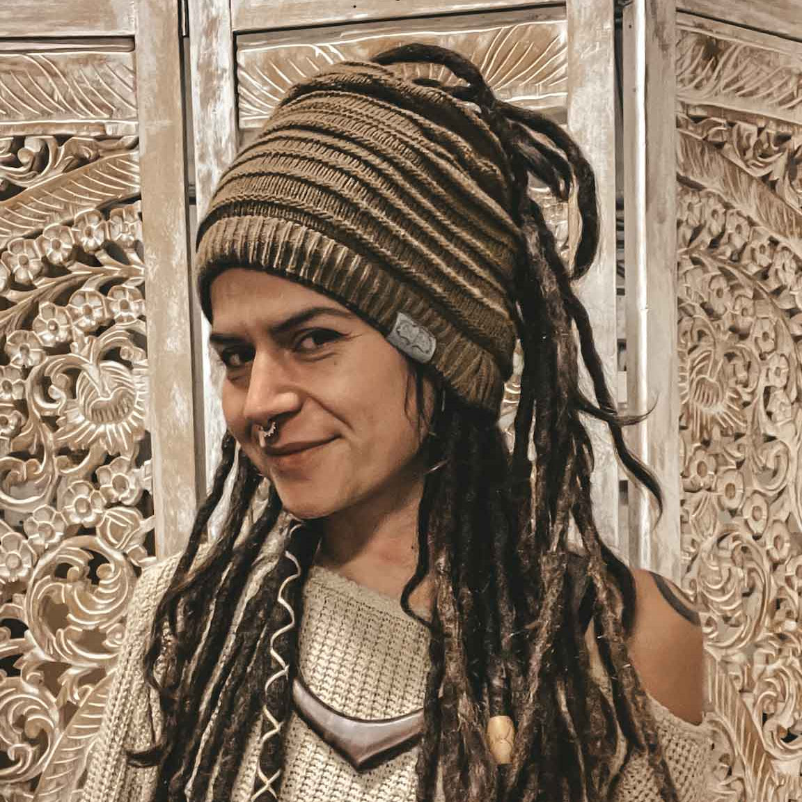 Person wearing a light brown CrafterElena Simple Stripes beanie with locs