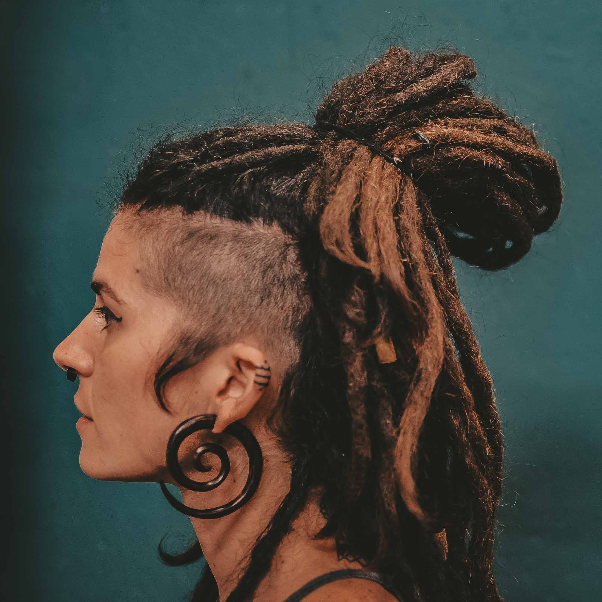 Person wearing CrafterElena Spiral Fake Gauge Earrings made from sono wood