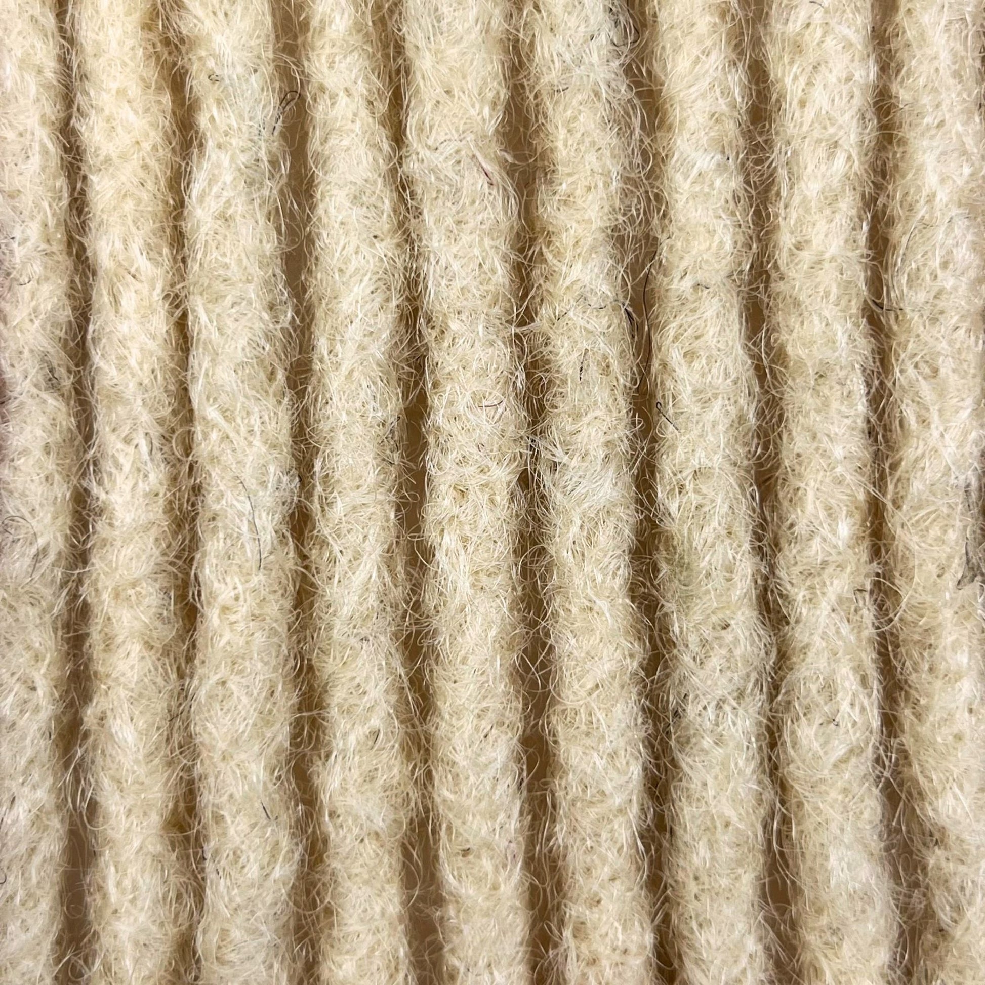 Close-up of Bleach Blonde kinky human hair loc extensions made using the crochet method.