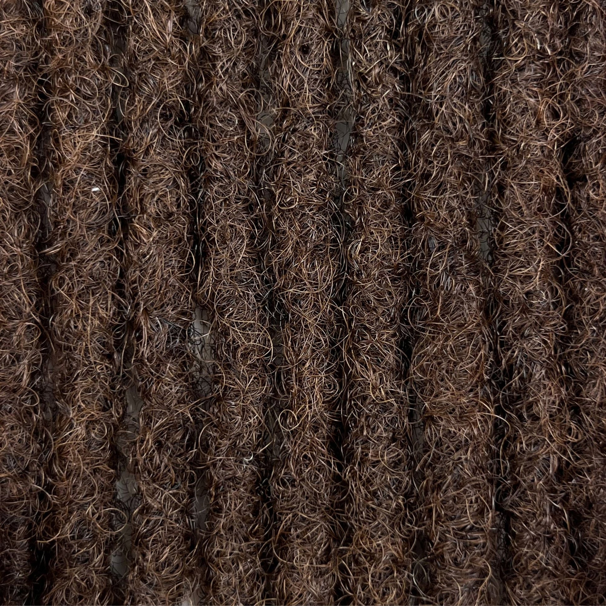 Close-up of Medium Brown kinky human hair loc extensions made using the crochet method.