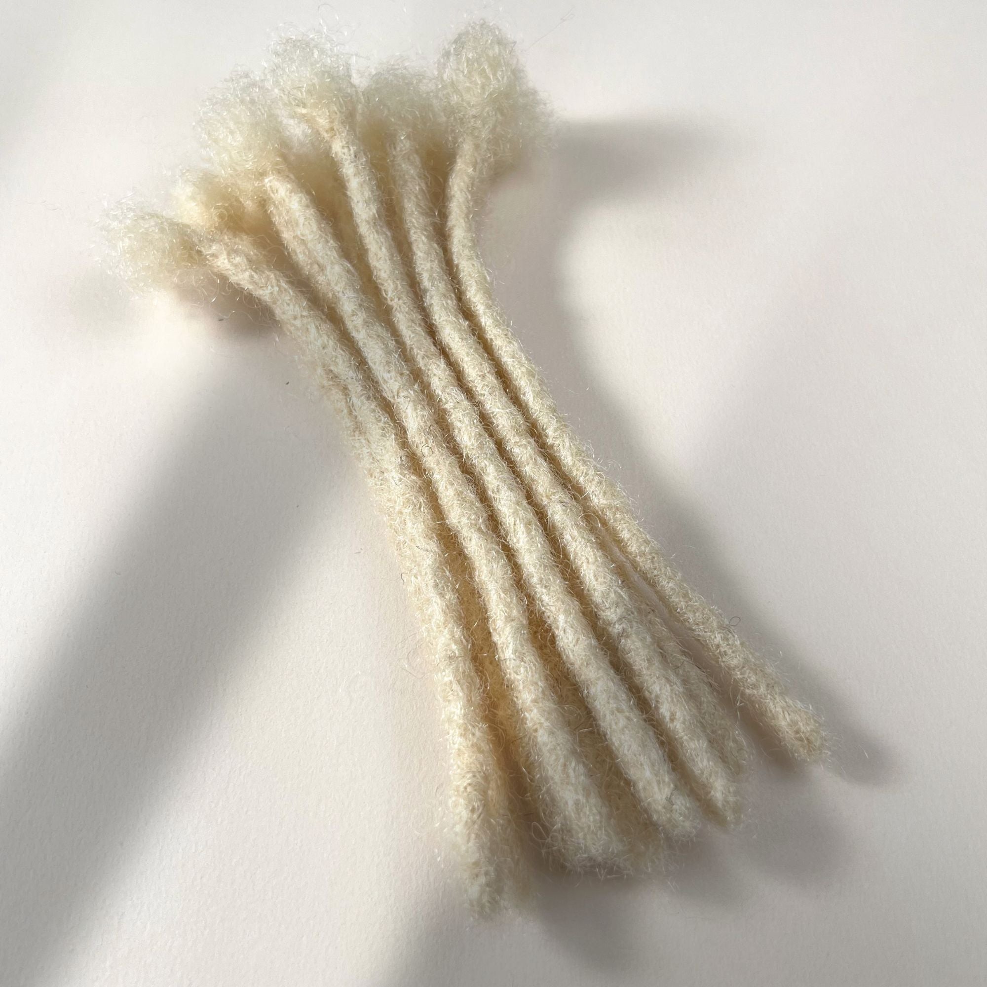 Bleach Blonde kinky human hair blunt end loc extensions made using the crochet method.