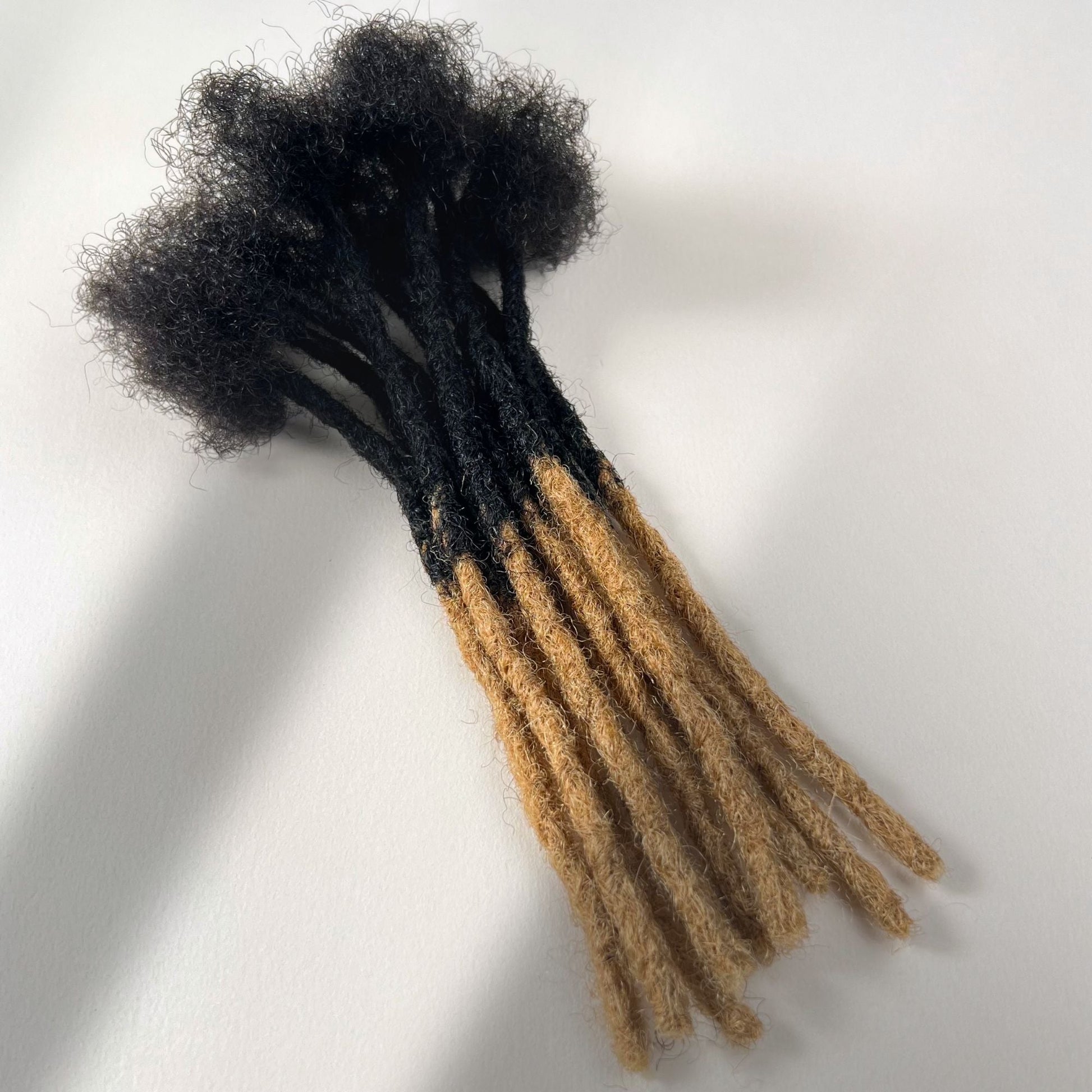 Honey Blonde Ombre kinky human hair blunt end loc extensions made using the crochet method.