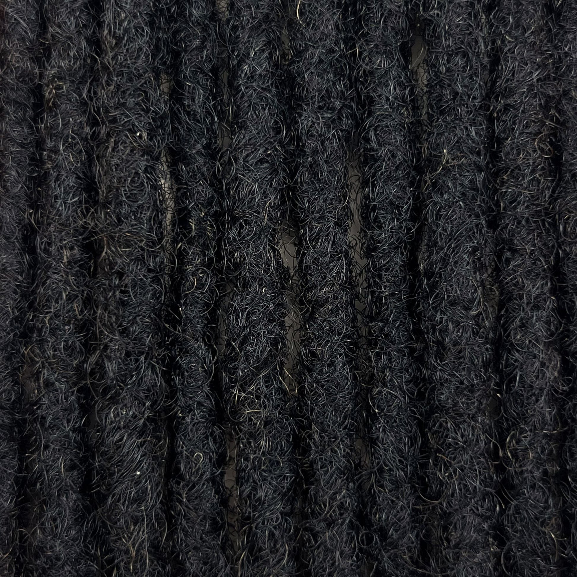 Close-up of Dark Brown kinky human hair loc extensions made using the crochet method.