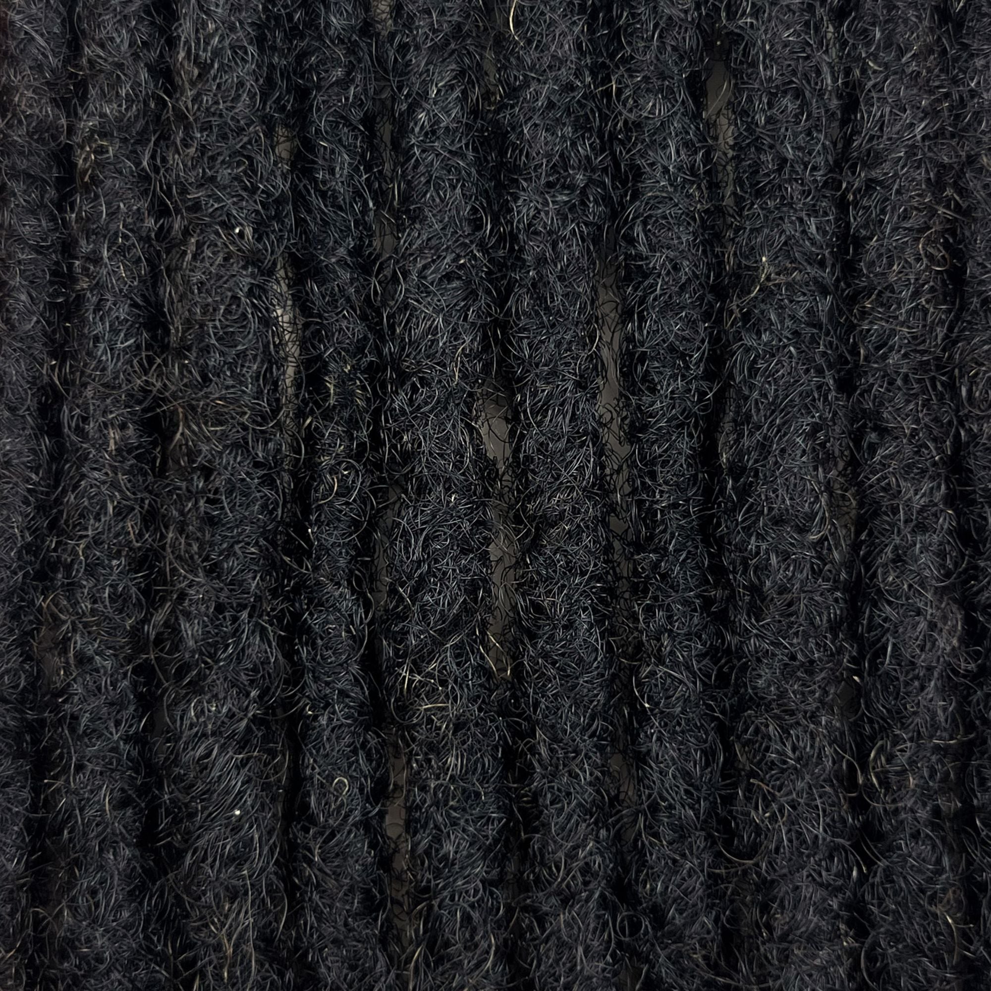 Close-up of Dark Brown kinky human hair loc extensions made using the crochet method.