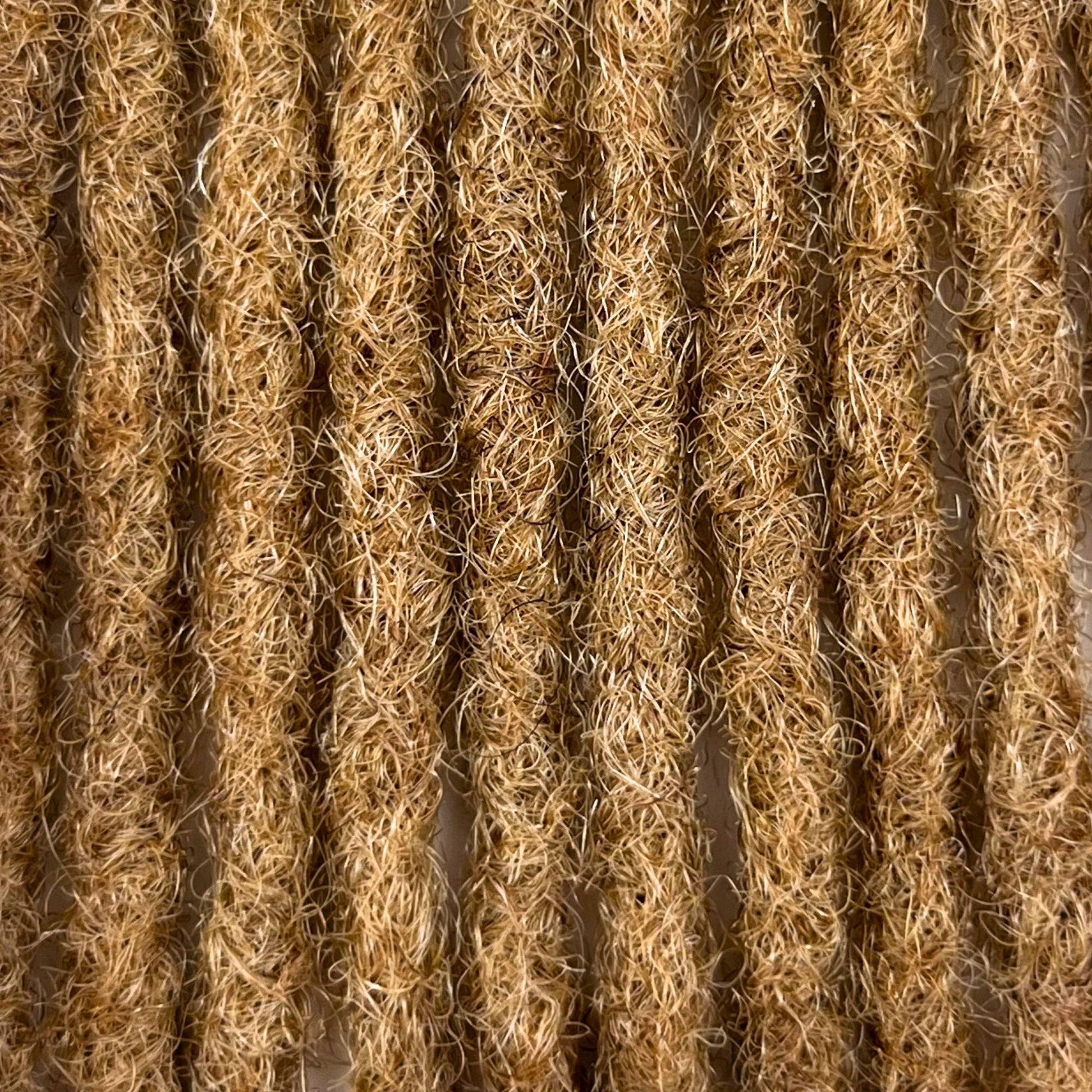 Close-up of Honey Blonde kinky human hair loc extensions made using the crochet method.