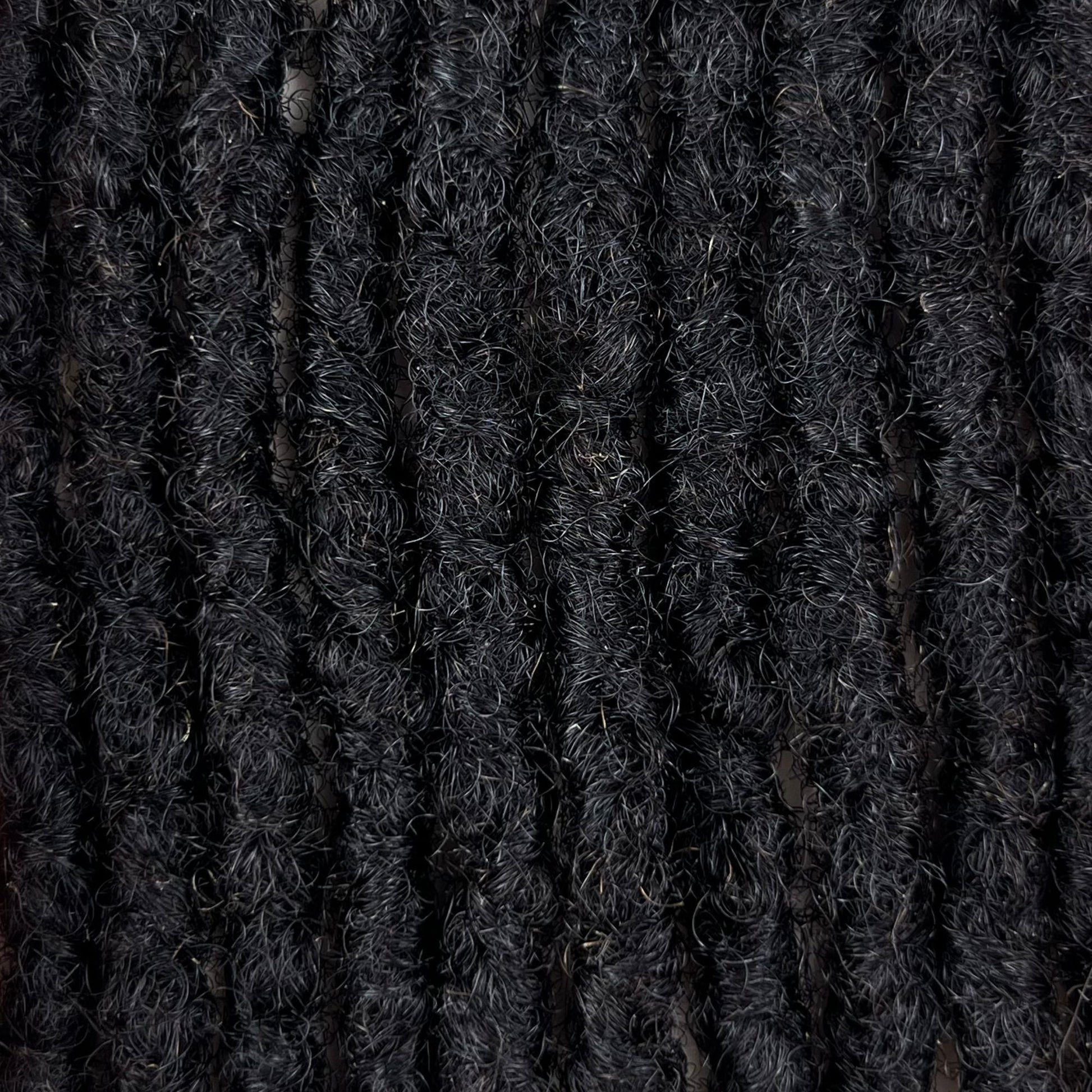 Close-up of Dark Brown kinky human hair loc extensions made using the interlocking method.