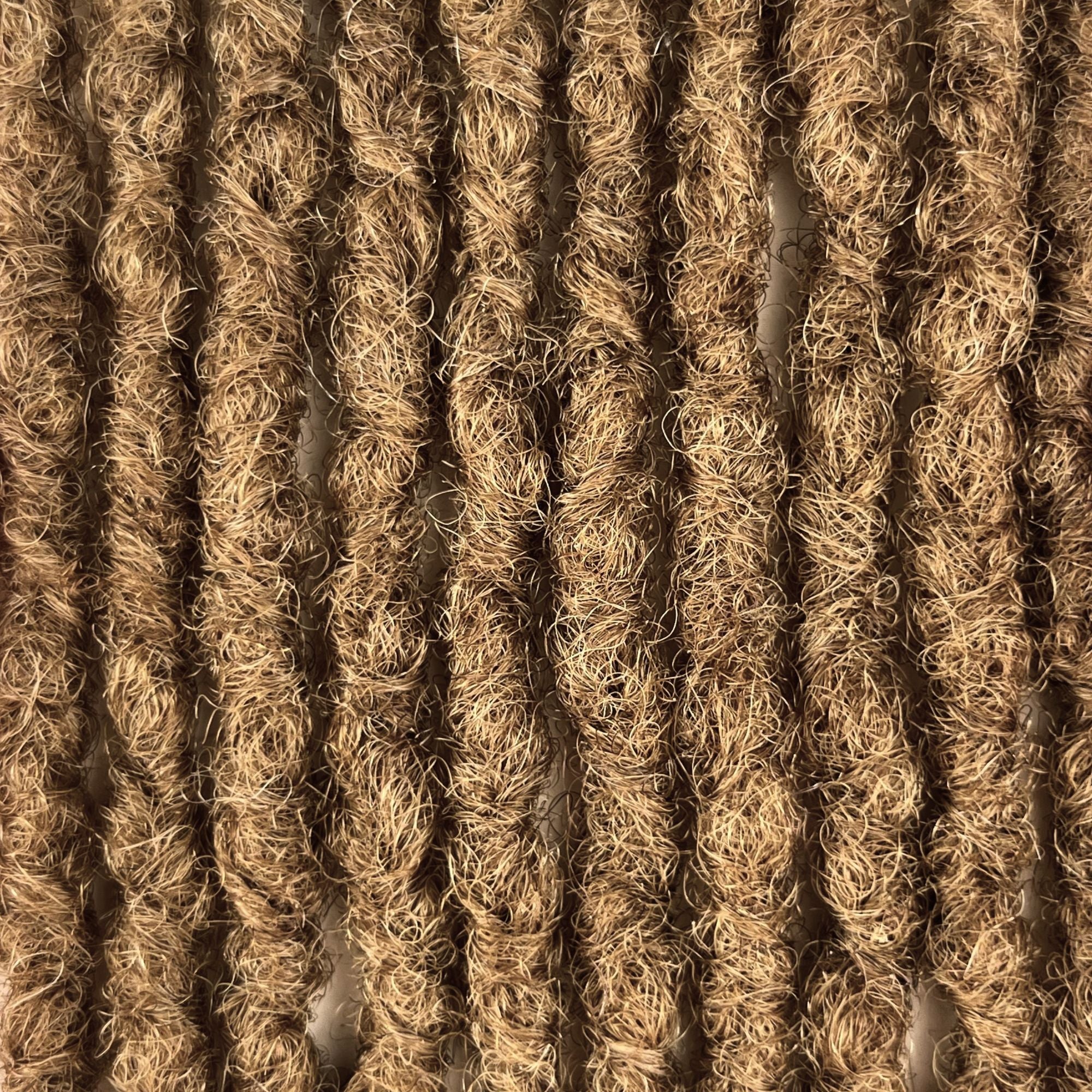 Close-up of Honey Blonde kinky human hair loc extensions made using the interlocking method.