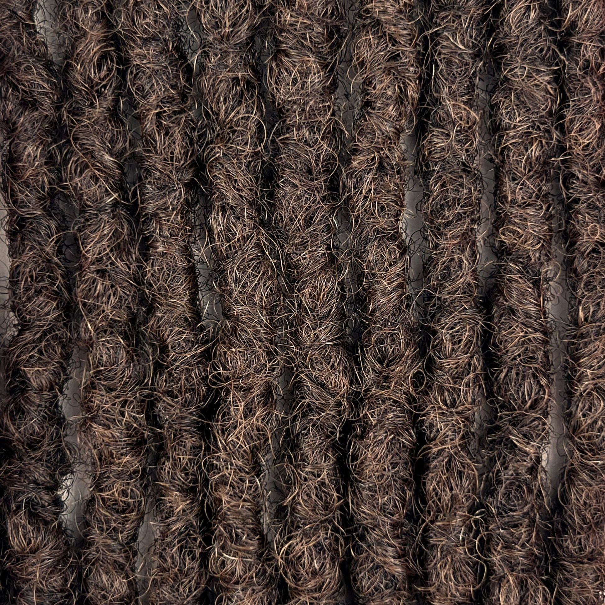 Close-up of Medium Brown kinky human hair loc extensions made using the interlocking method.