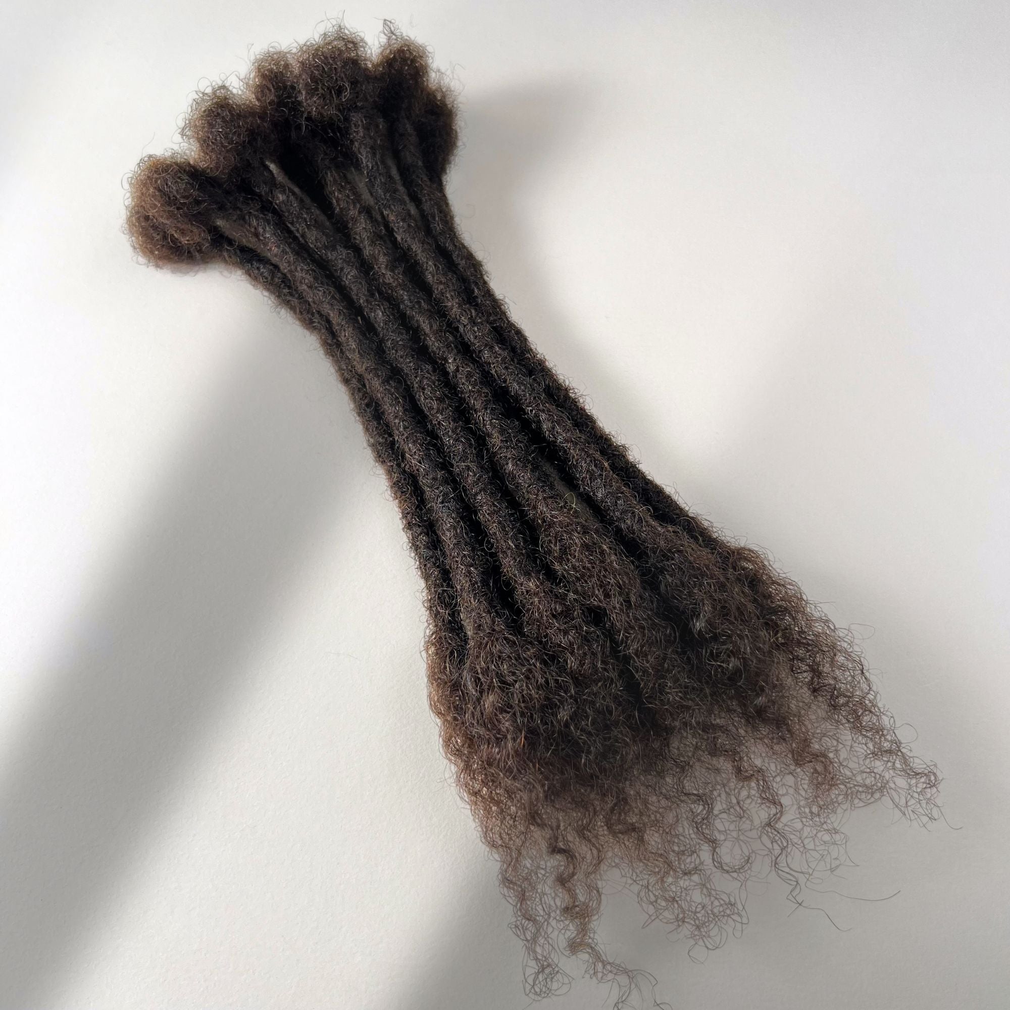 Dark Brown kinky human hair open end loc extensions made using the crochet method.