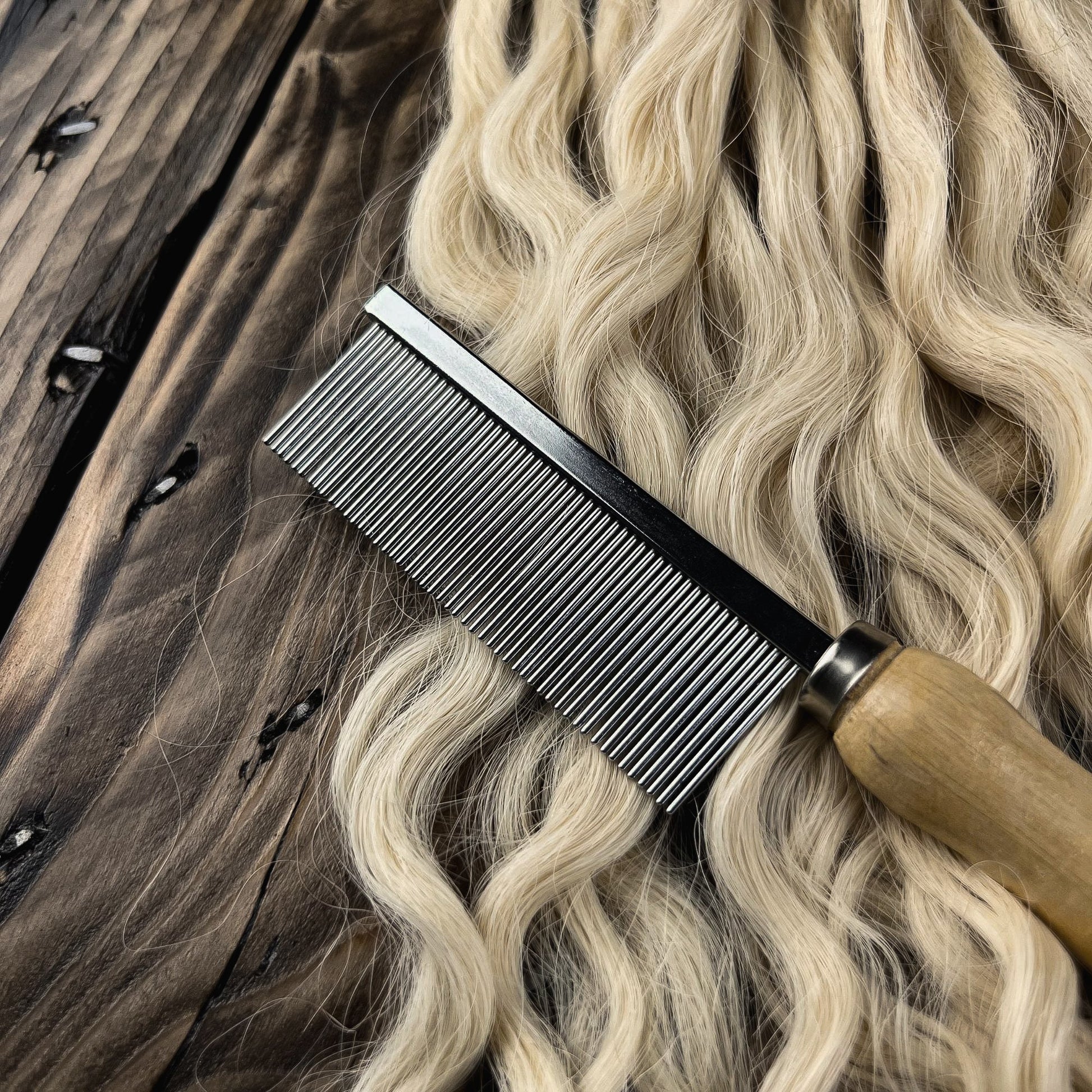 Close-up of the Loc Comb on wavy human hair for detangling, sectioning, and preparing hair for handcrafted Loc creation.