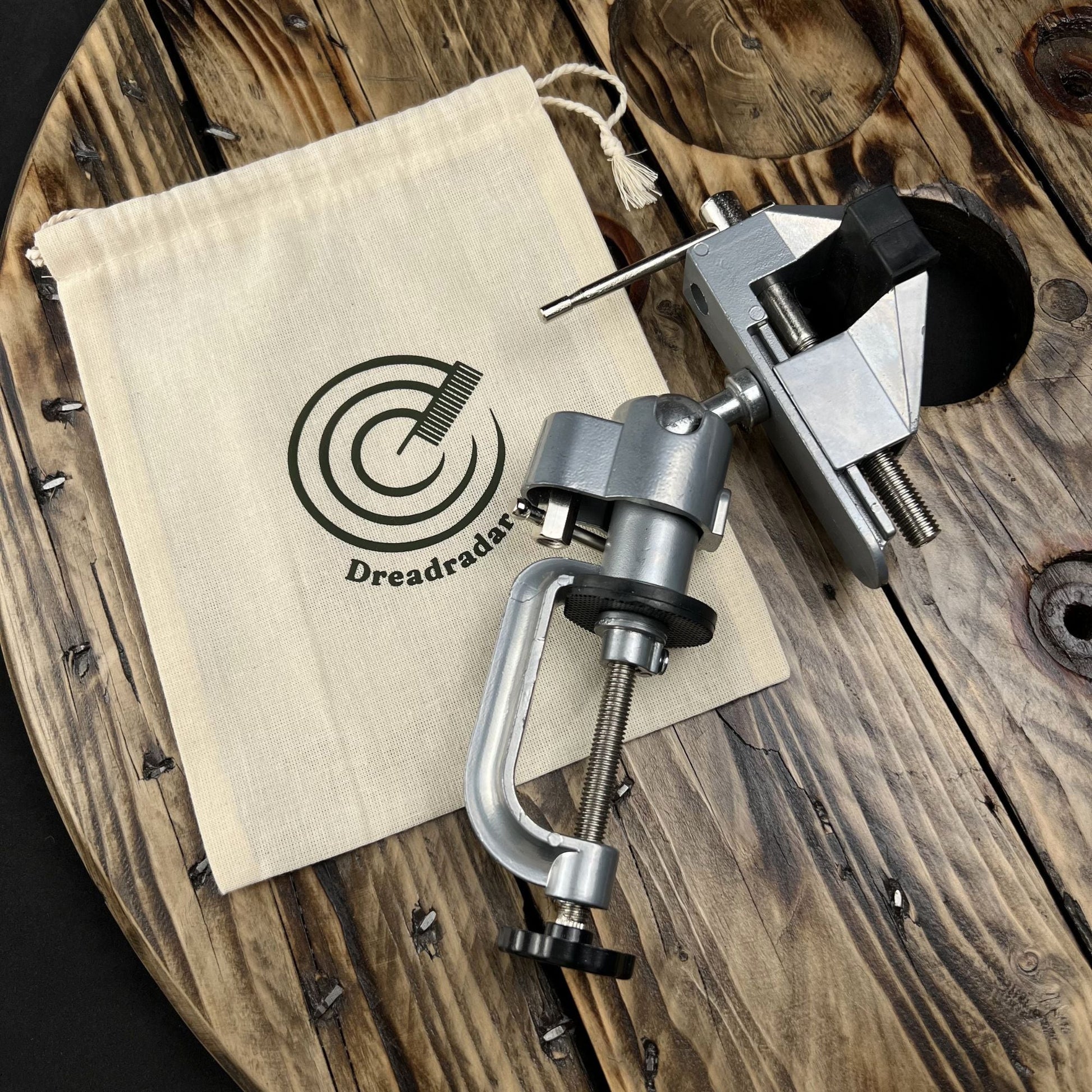 Loc Vise and storage pouch shown in a flat lay for creating handcrafted Locs.