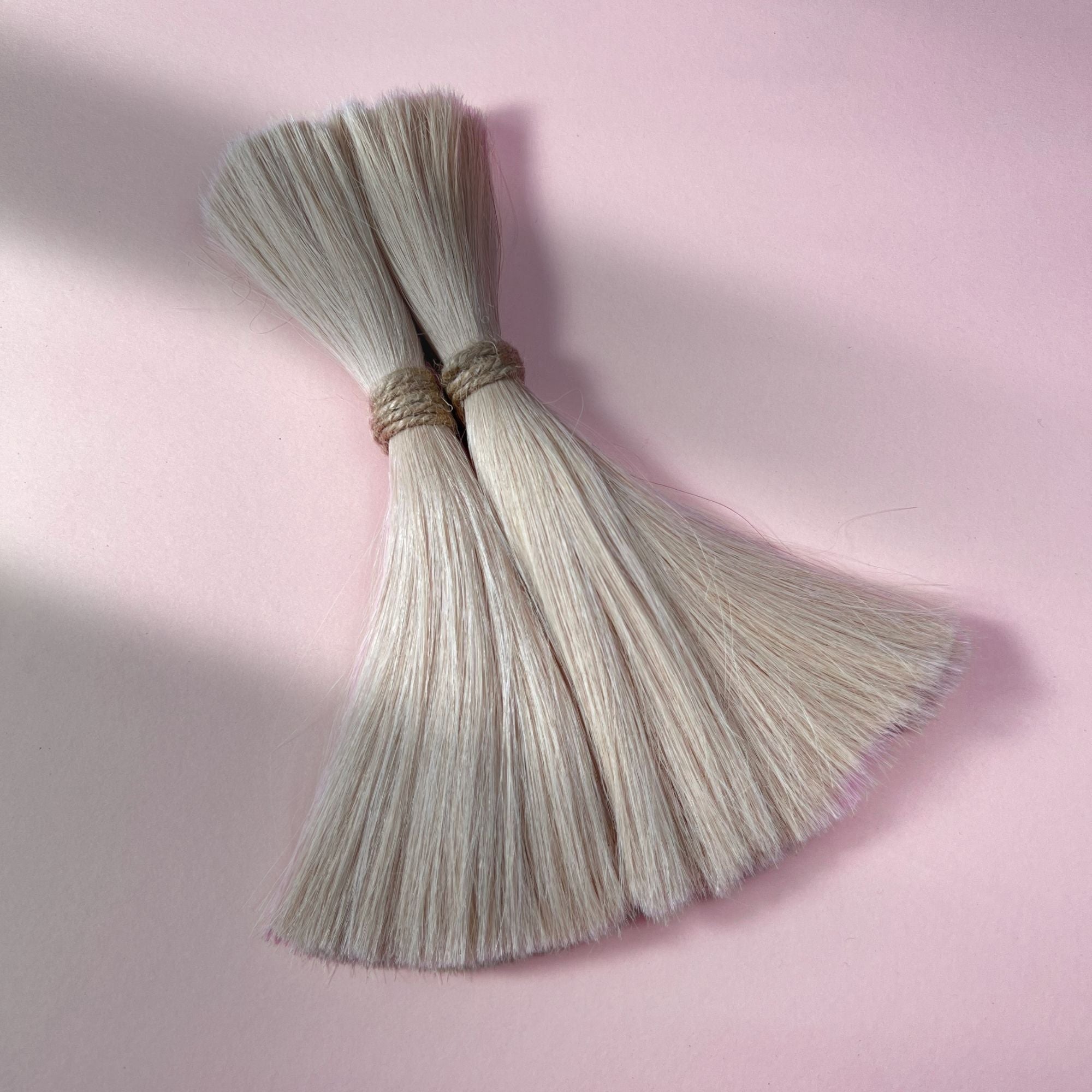 Full view of straight human hair in Cool Ash Blonde.