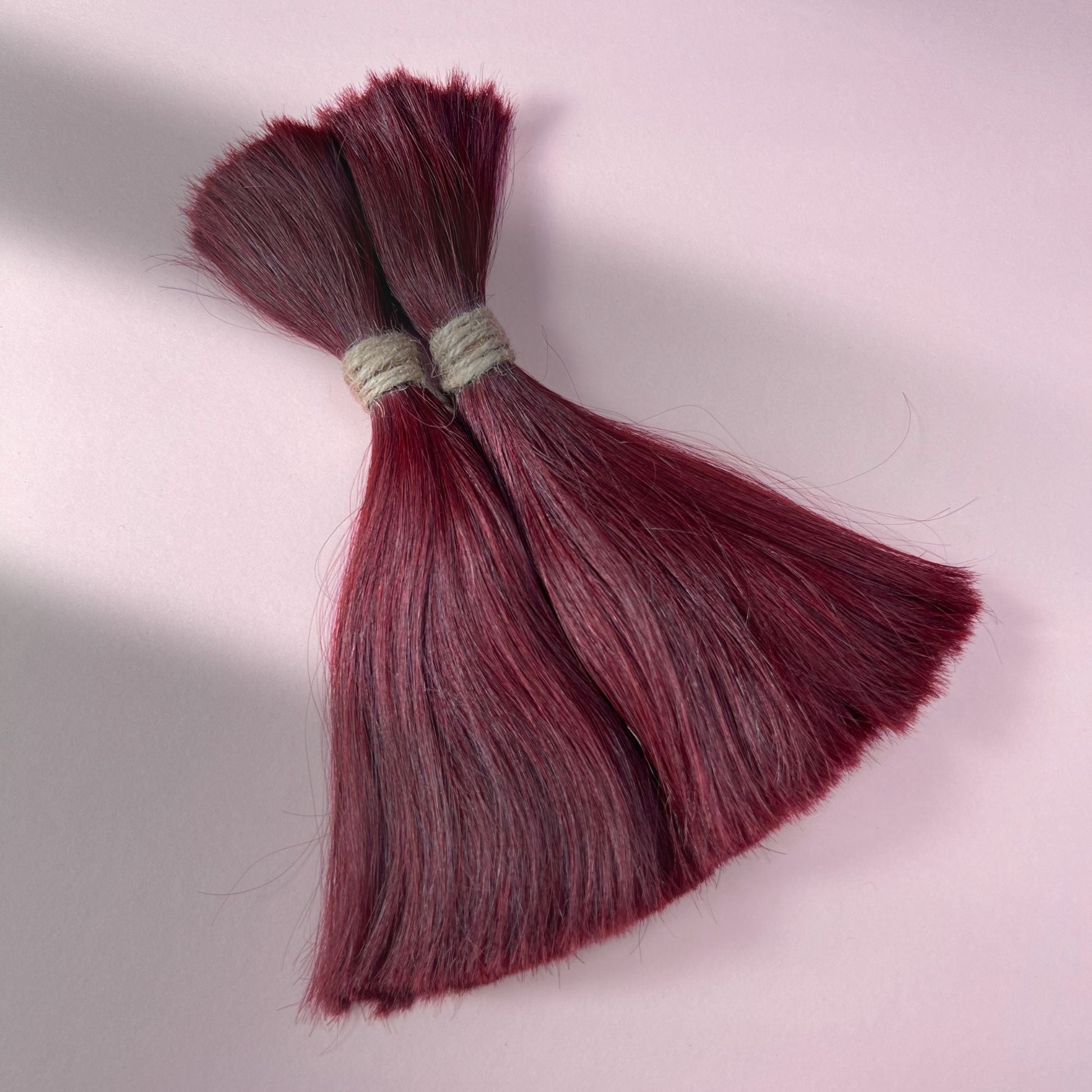 Full view of straight human hair in Rich Burgundy Red.
