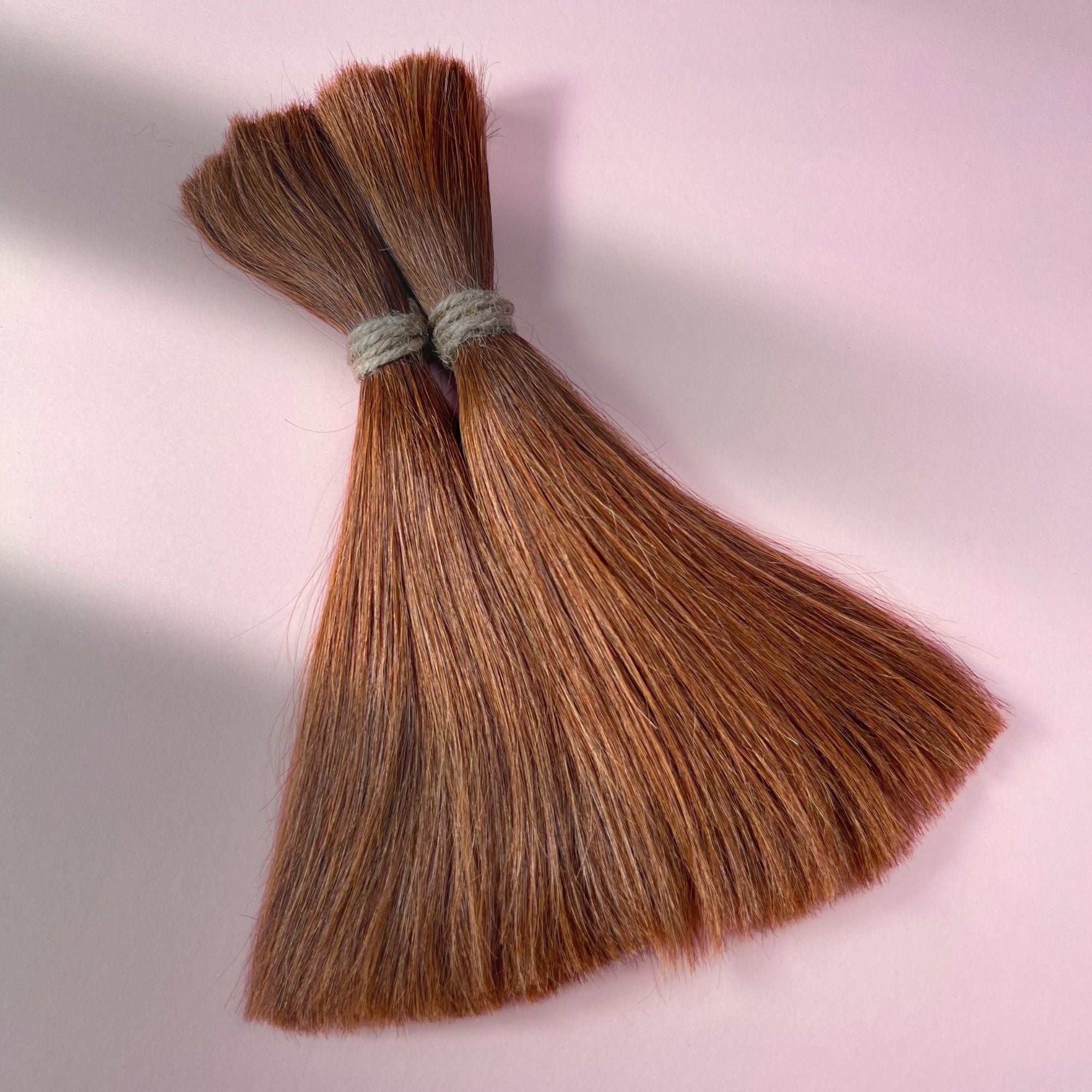 Full view of straight human hair in Burnt Sienna Copper.