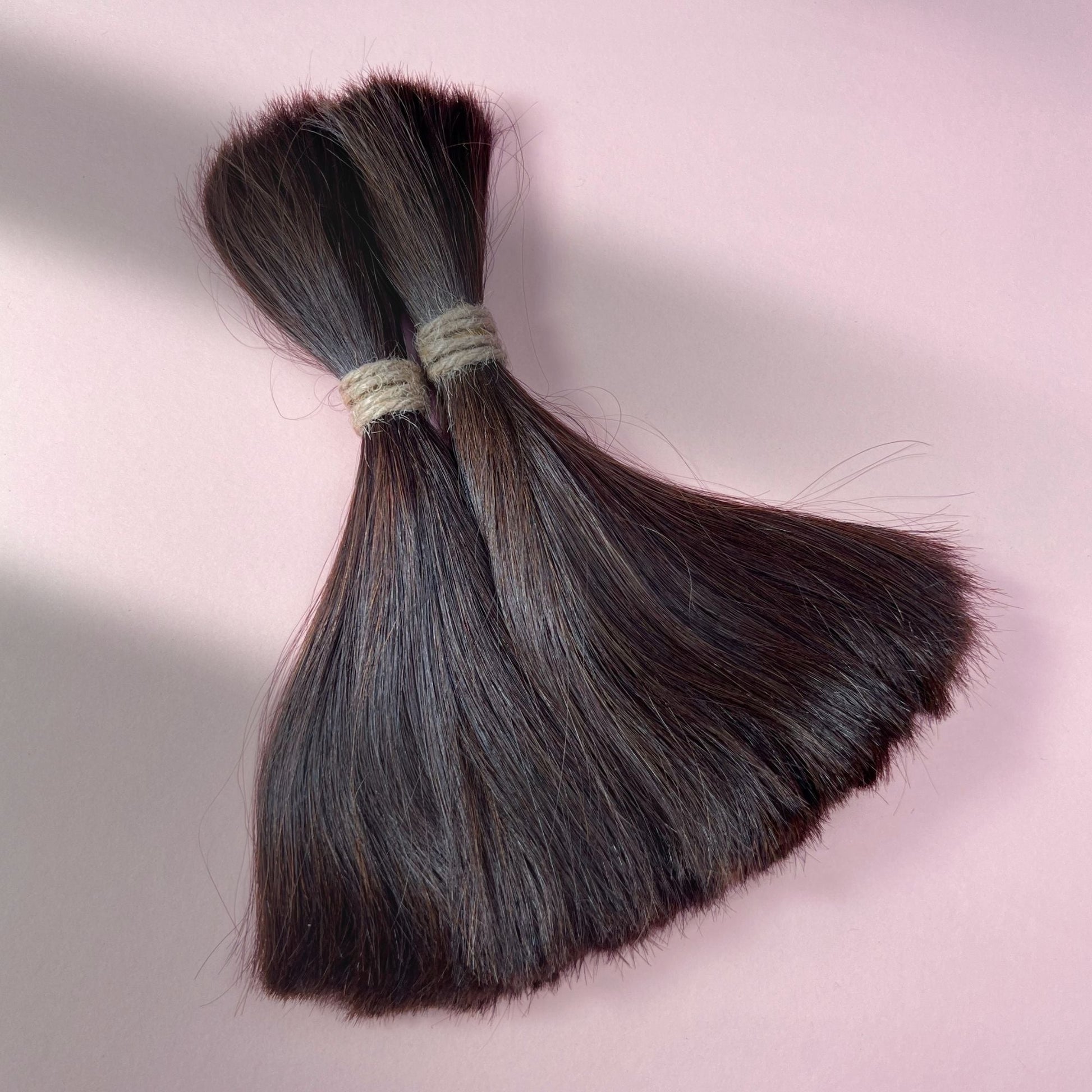 Full view of straight human hair in Warm Caramel Brown.