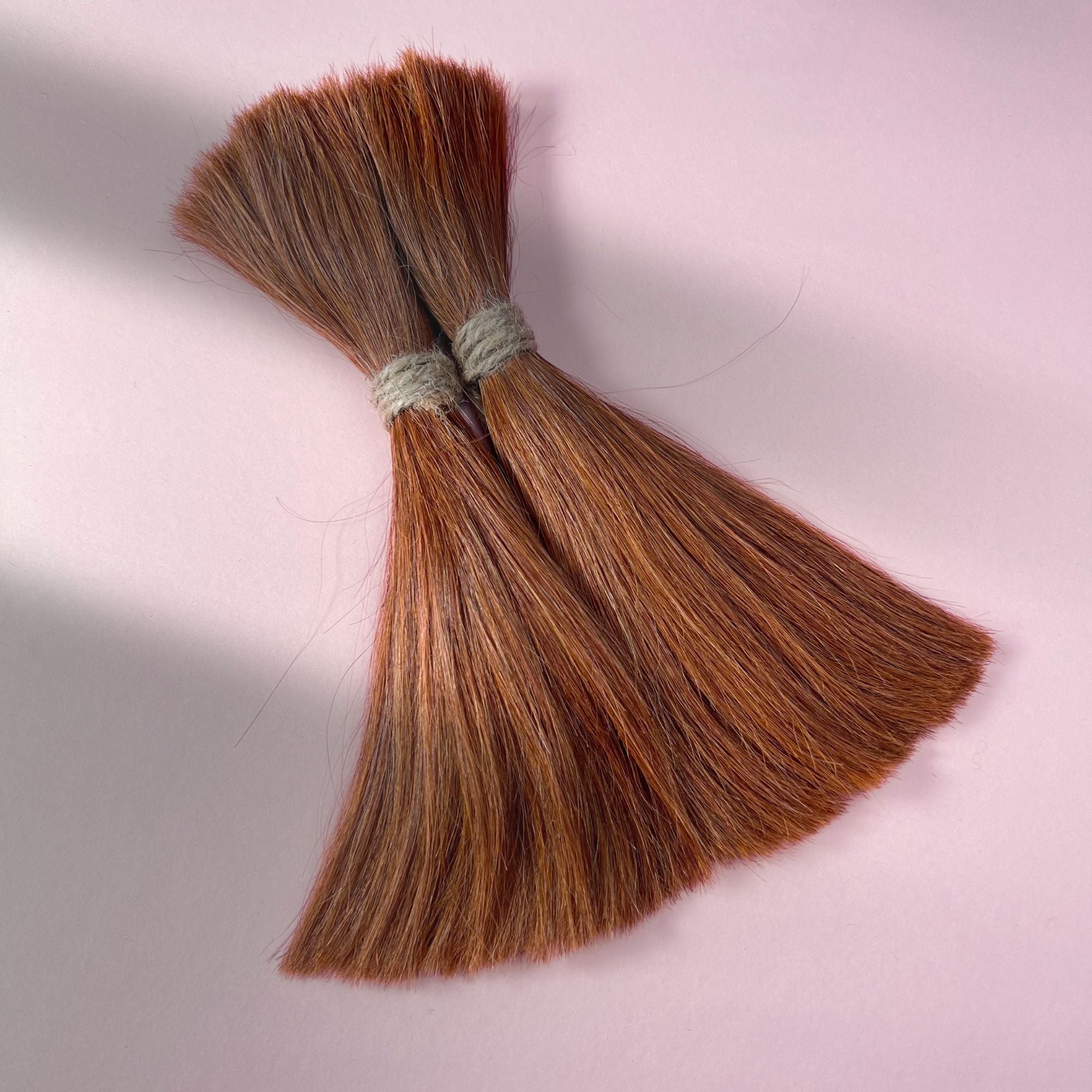 Full view of straight human hair in Burnt Copper.