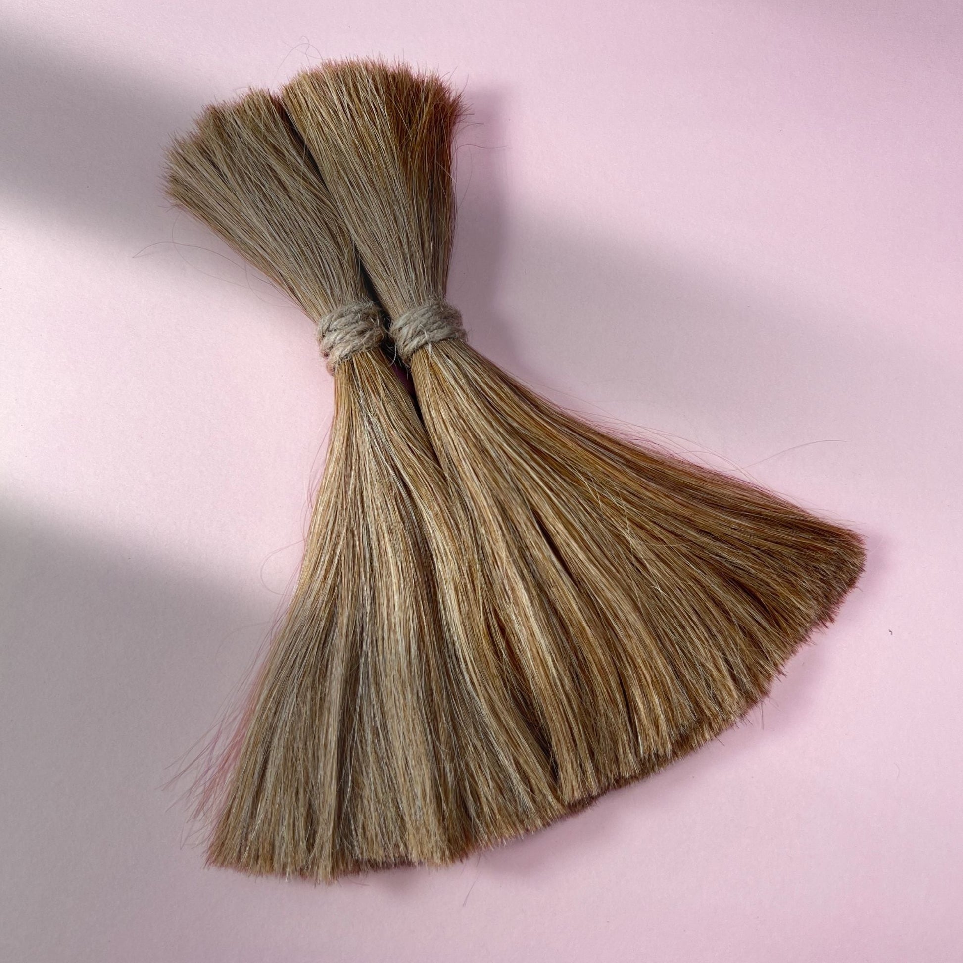 Full view of straight human hair in Honey Blonde.