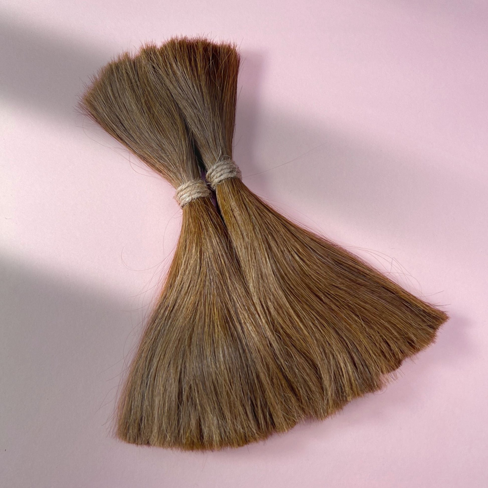 Full view of straight human hair in Honey Brown.