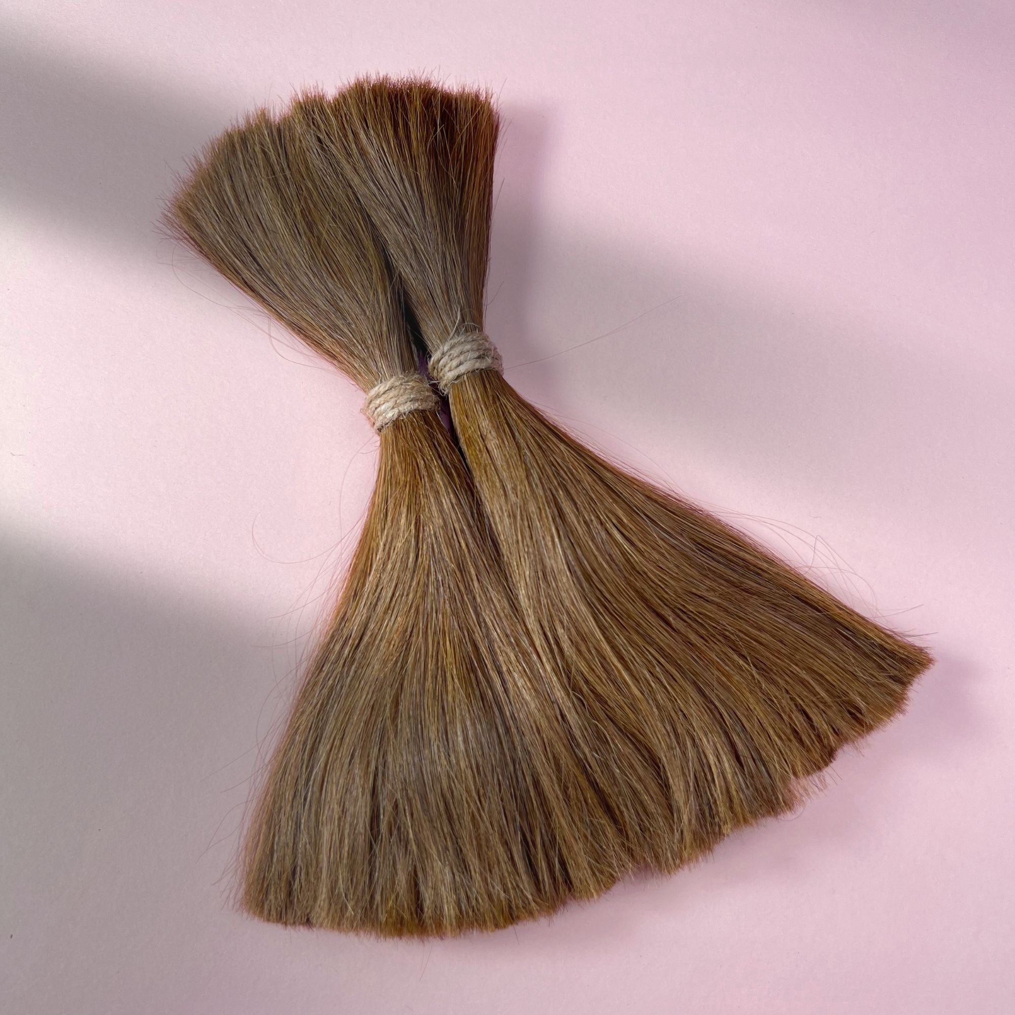 Full view of straight human hair in Honey Brown.
