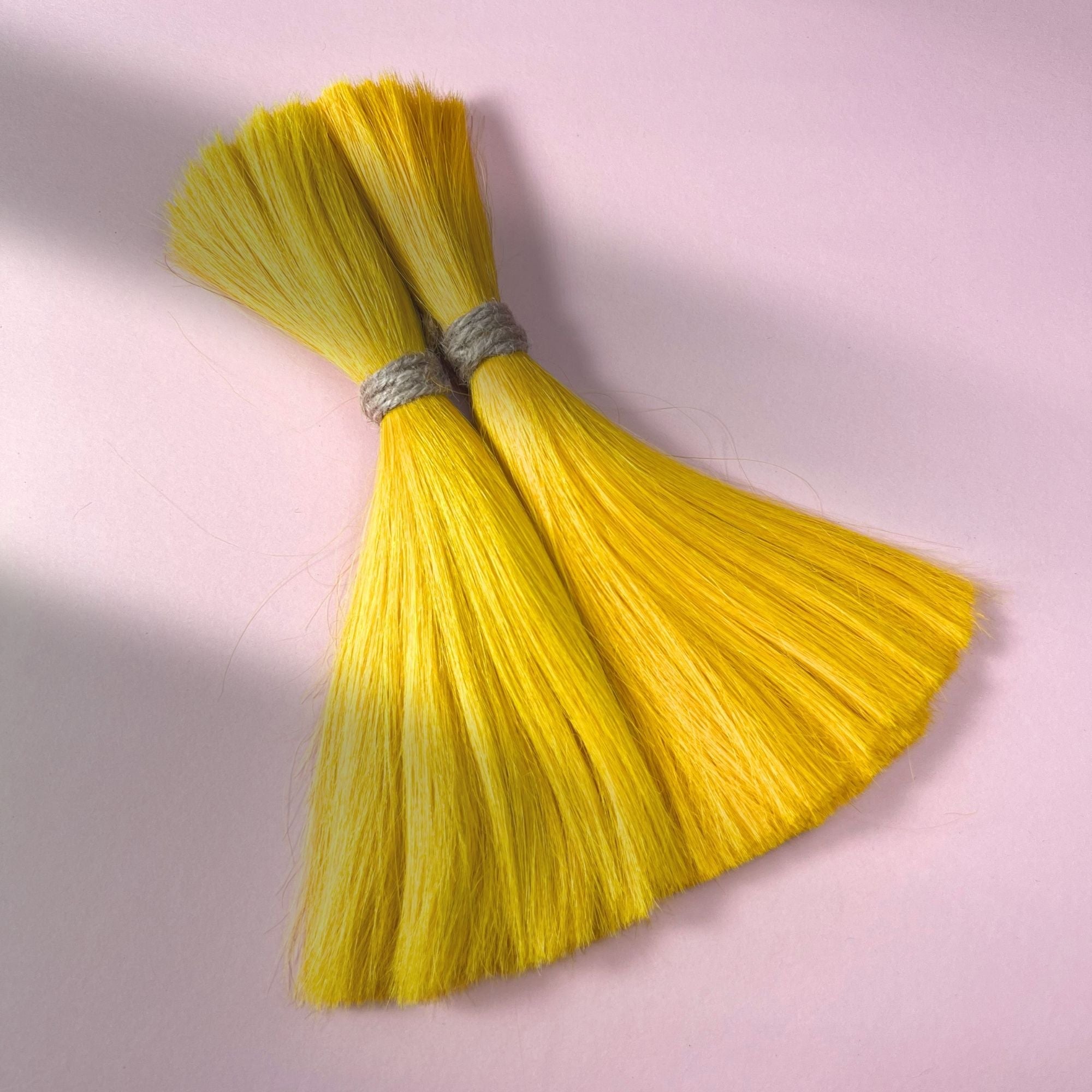 Full view of straight human hair in Lemon Yellow.