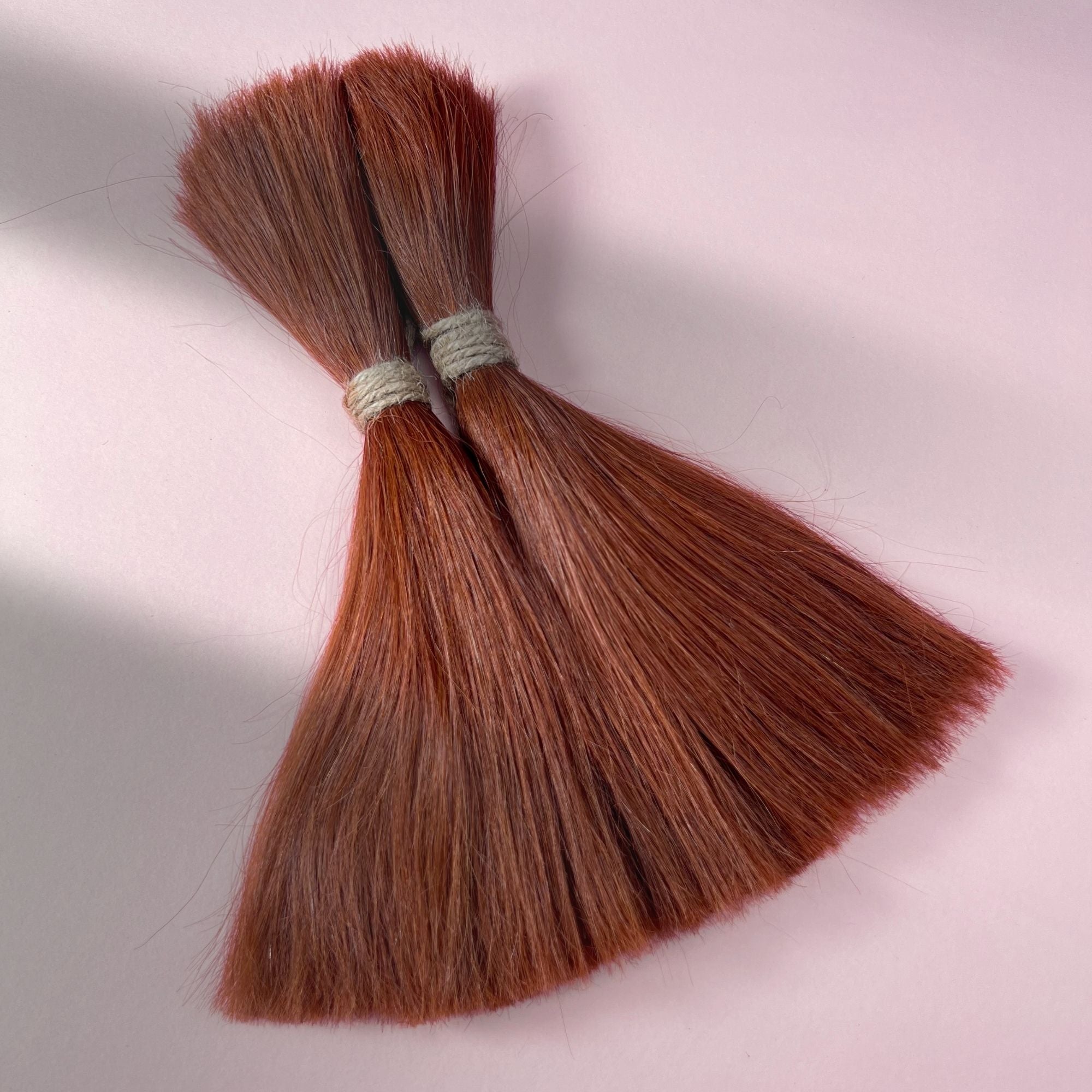 Full view of straight human hair in Warm Maple Copper.