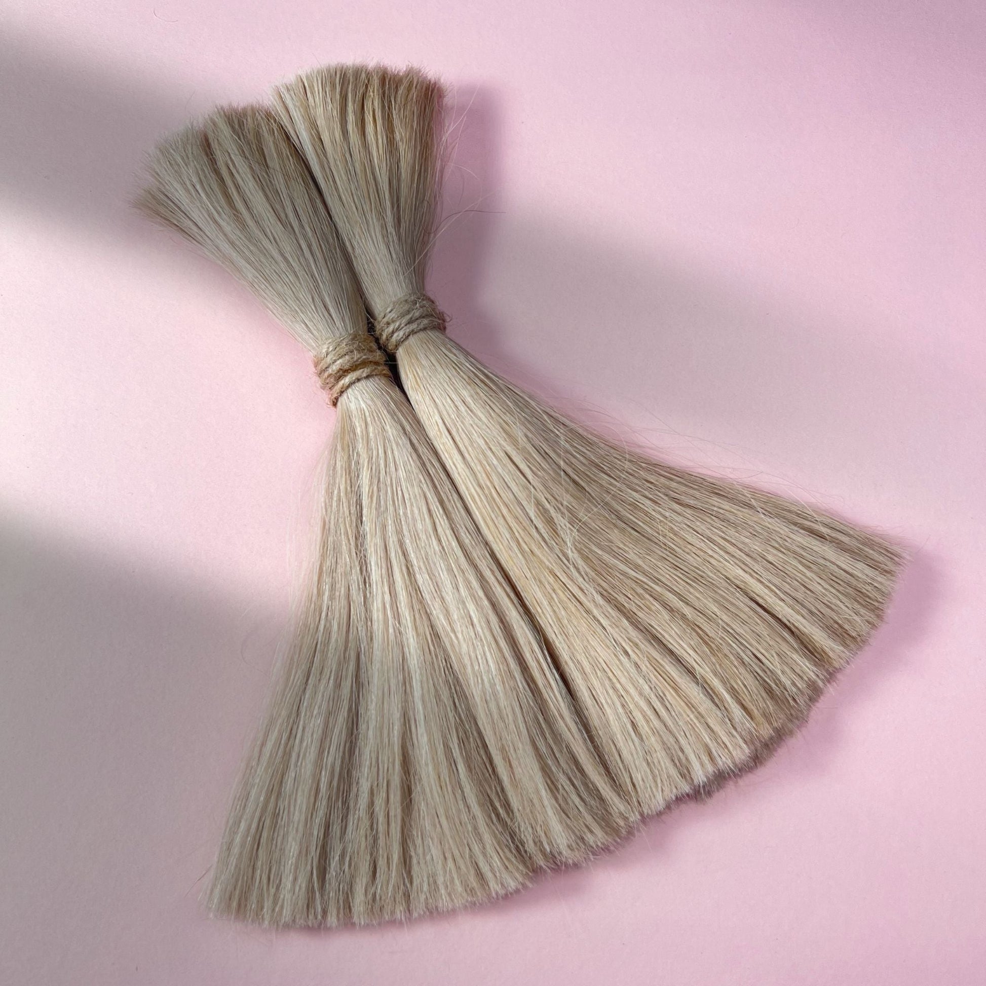 Full view of straight human hair in Cream Blonde.