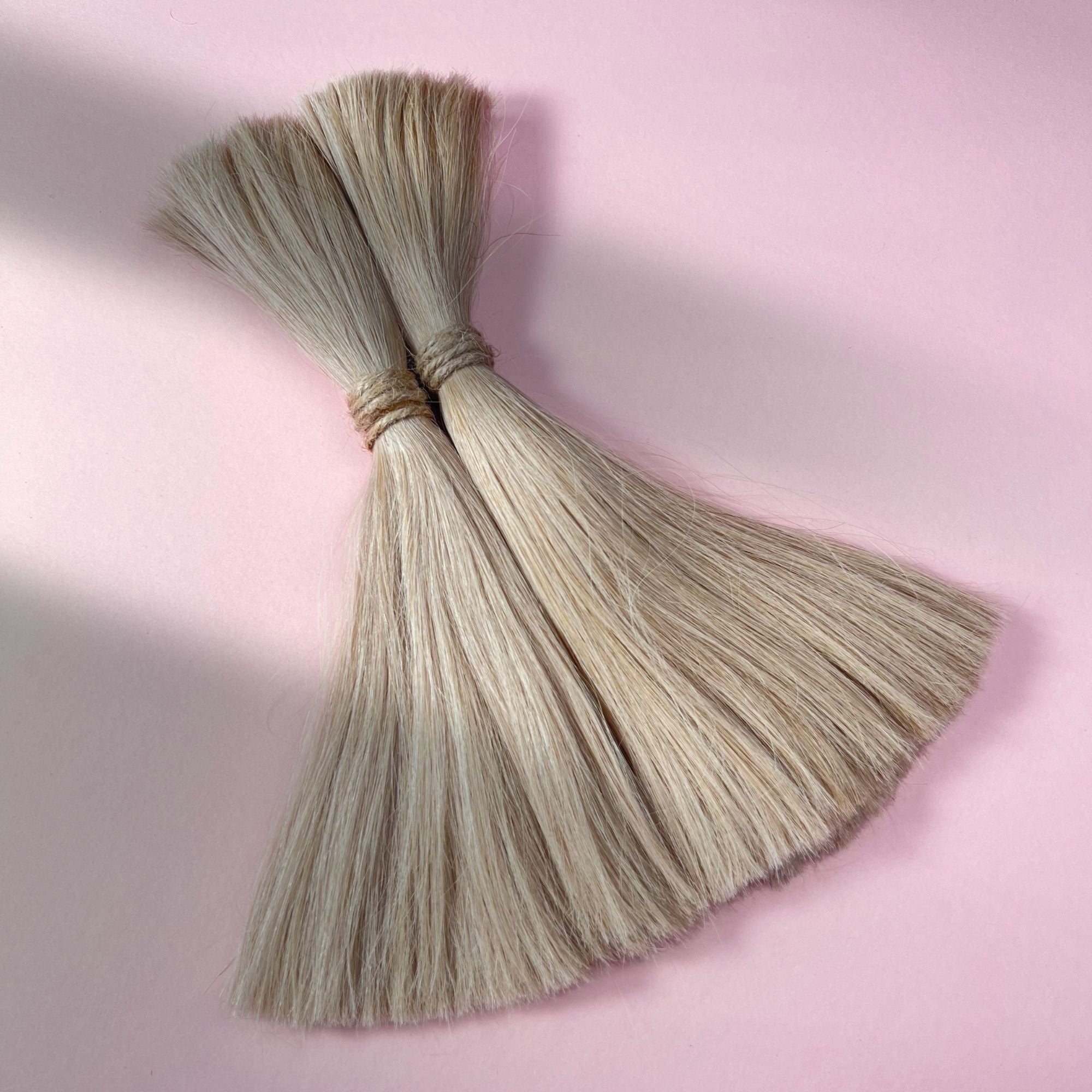 Full view of straight human hair in Cream Blonde.