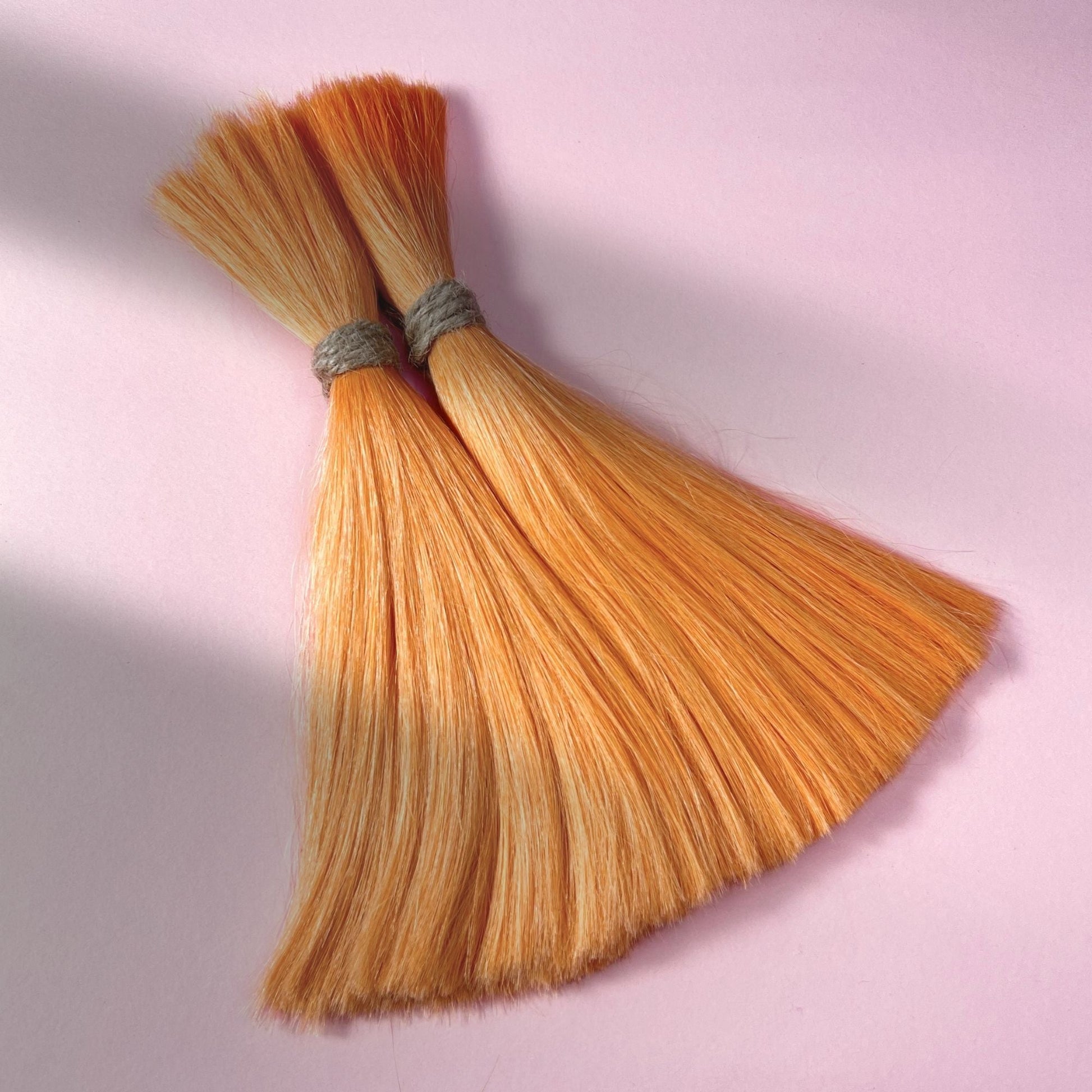 Full view of straight human hair in Peach Orange.