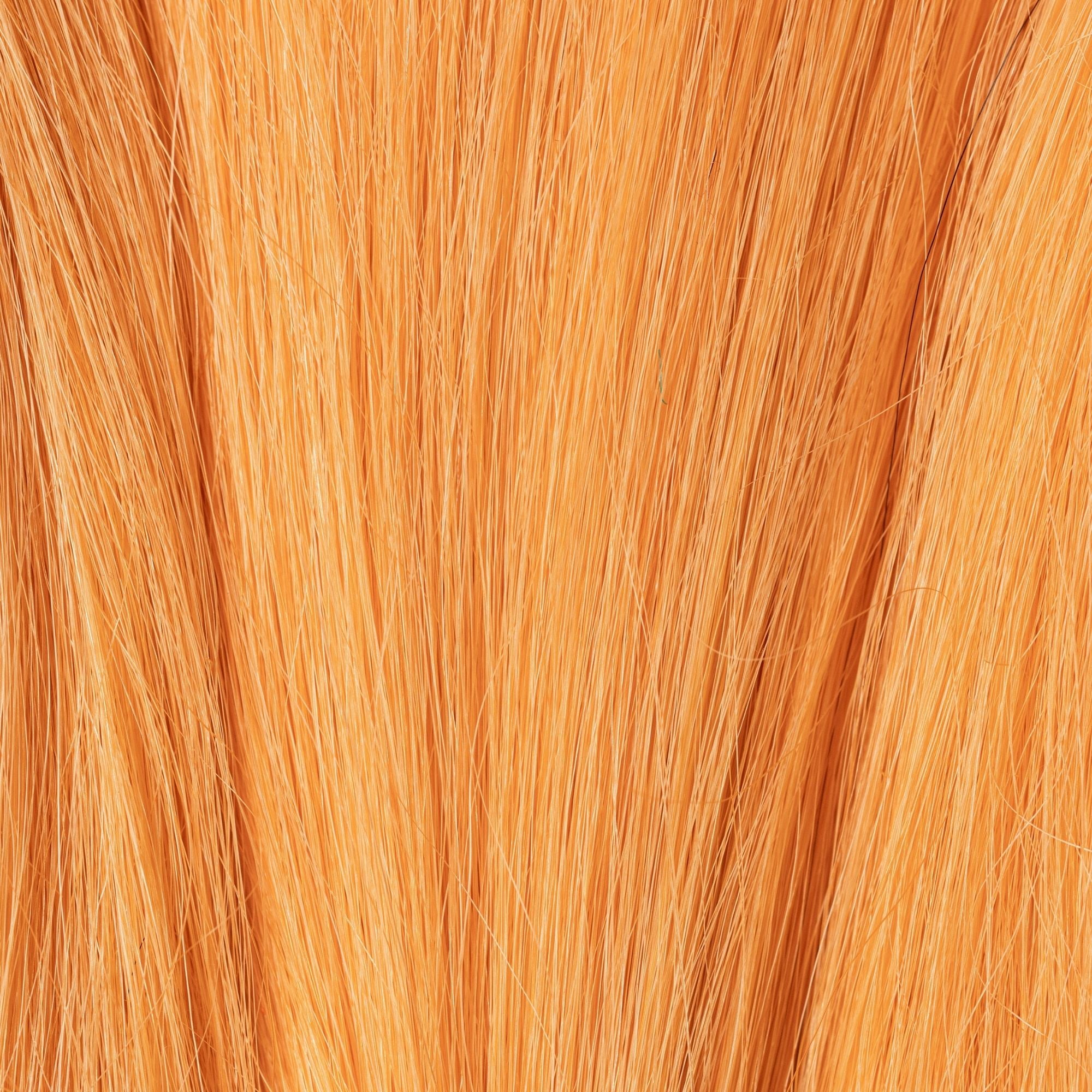 Close-up of Peach Fuzz loose human hair texture for Straight Loc Extensions