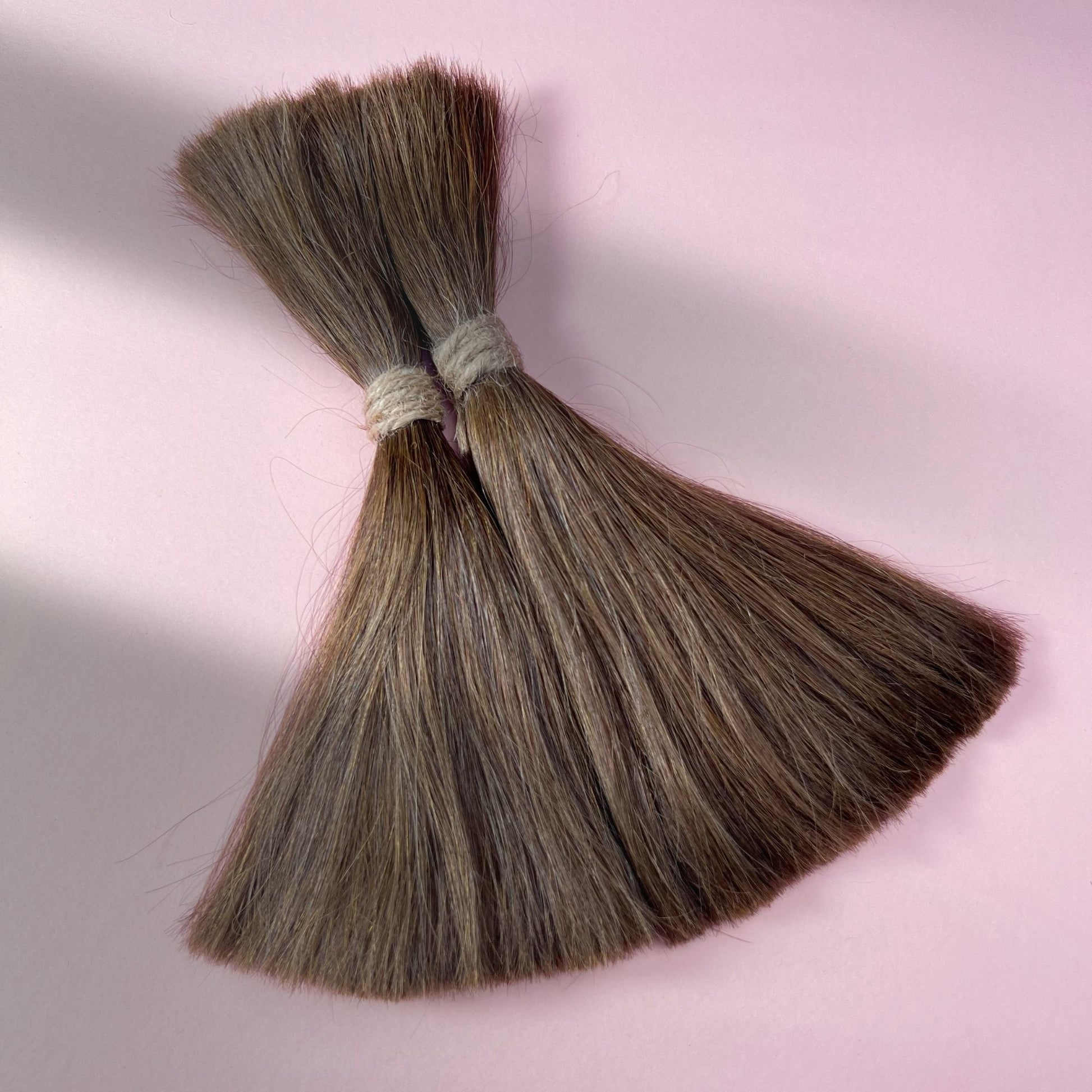 Full view of straight human hair in Natural Medium Brown.