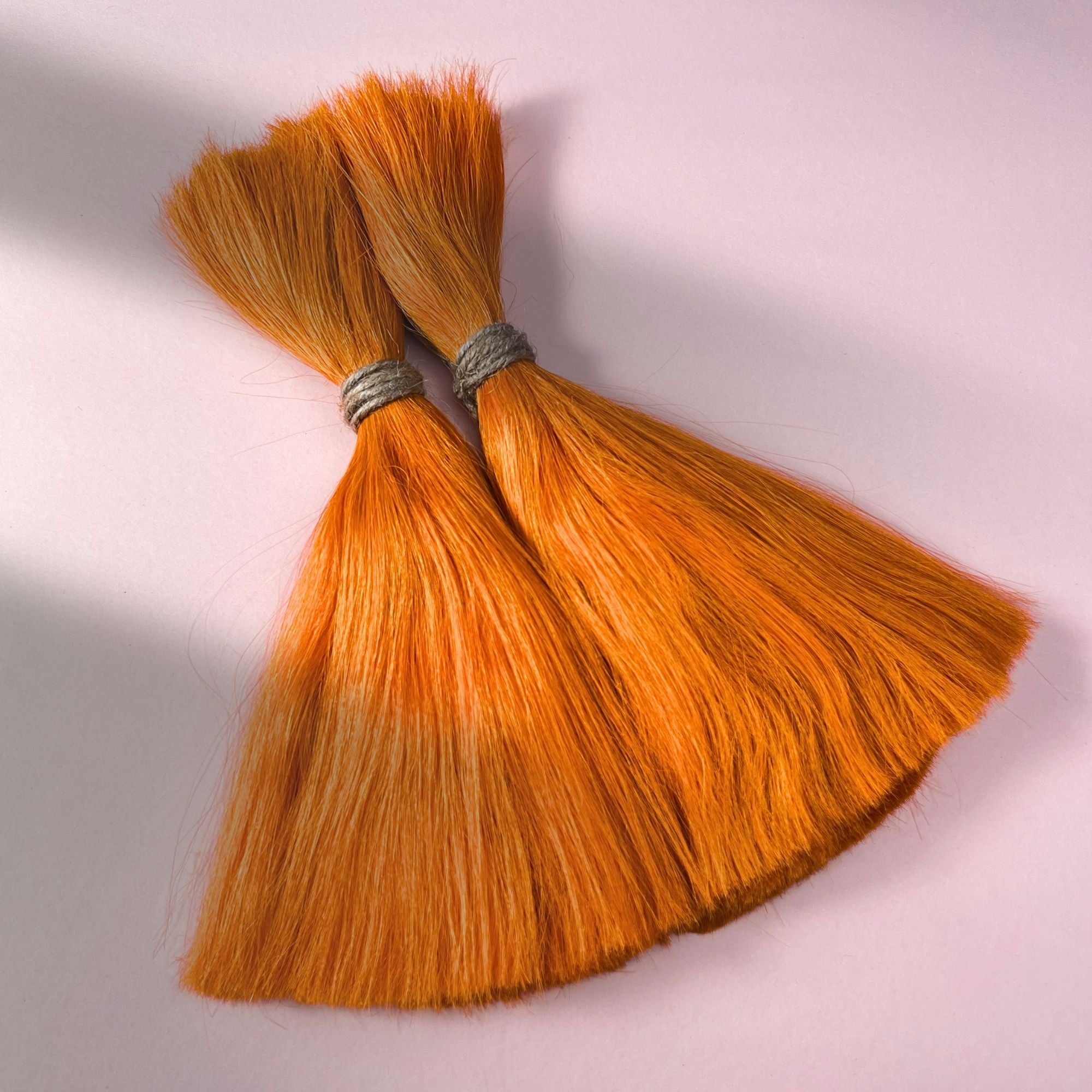 Full view of straight human hair in Burnt Orange.