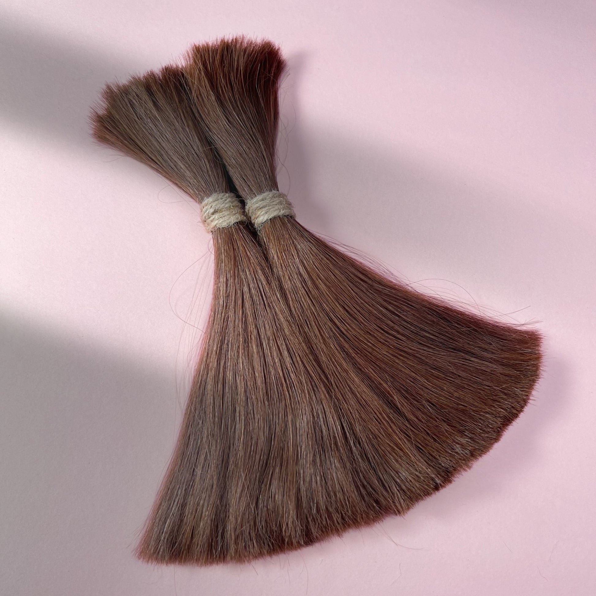 Full view of straight human hair in Warm Cinnamon Brown.