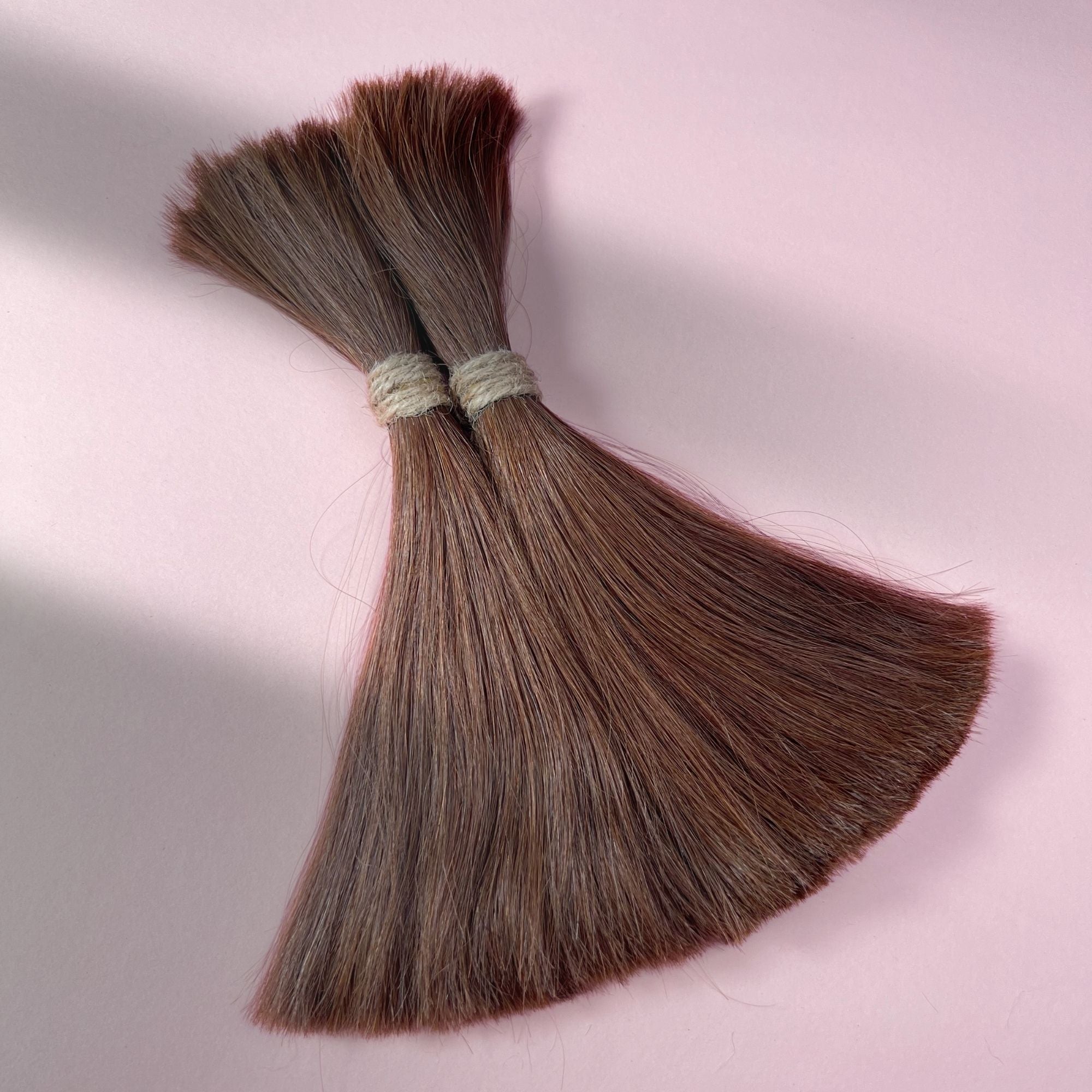 Full view of straight human hair in Warm Cinnamon Brown.