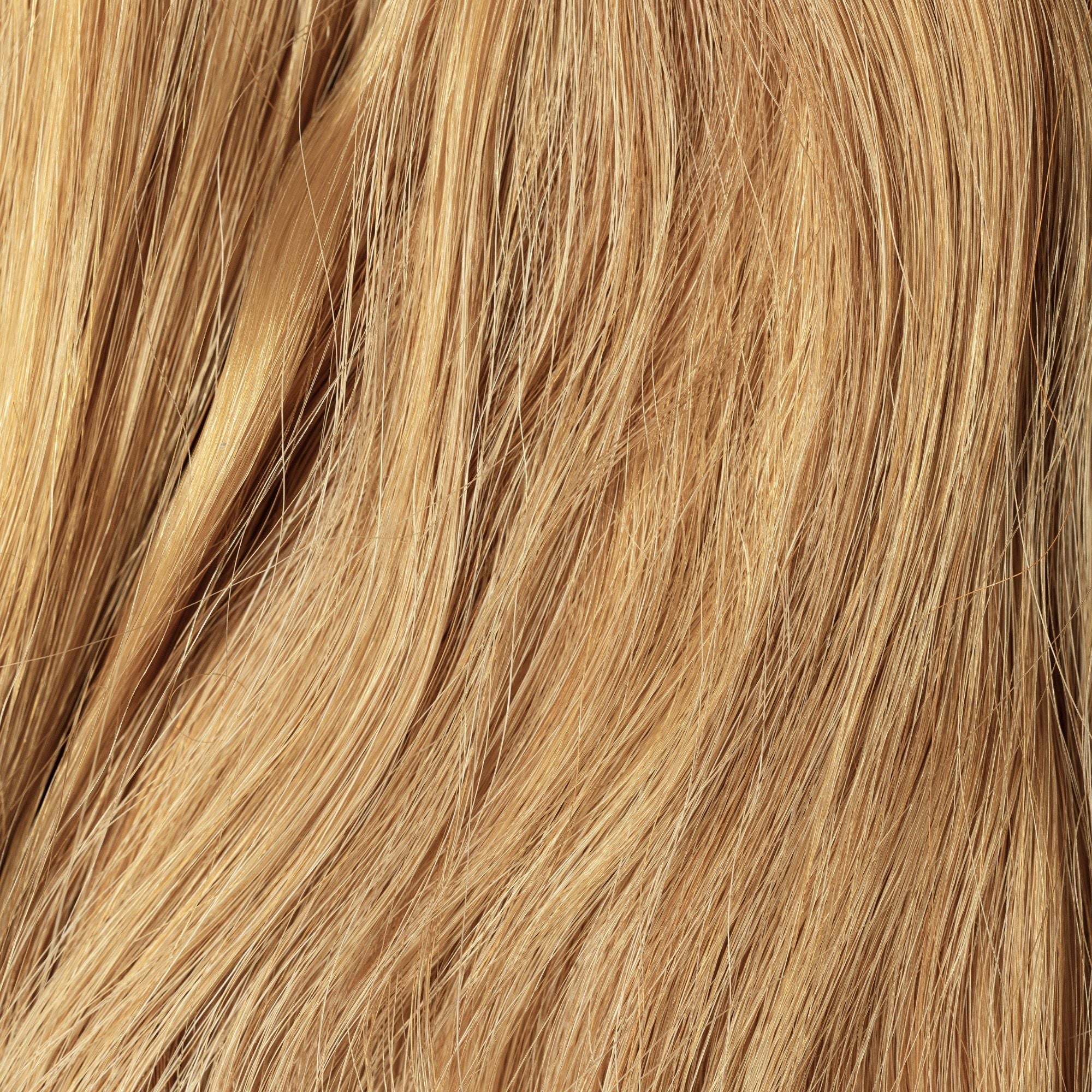 Close-up of Sunkissed loose human hair texture for Straight Loc Extensions