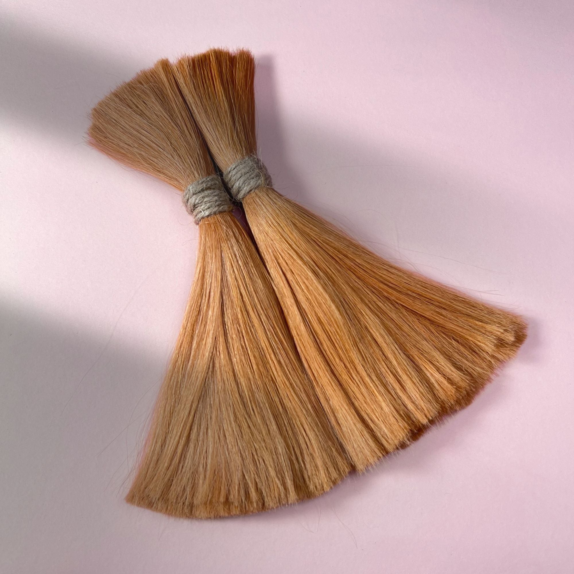 Full view of straight human hair in Warm Copper Blonde.