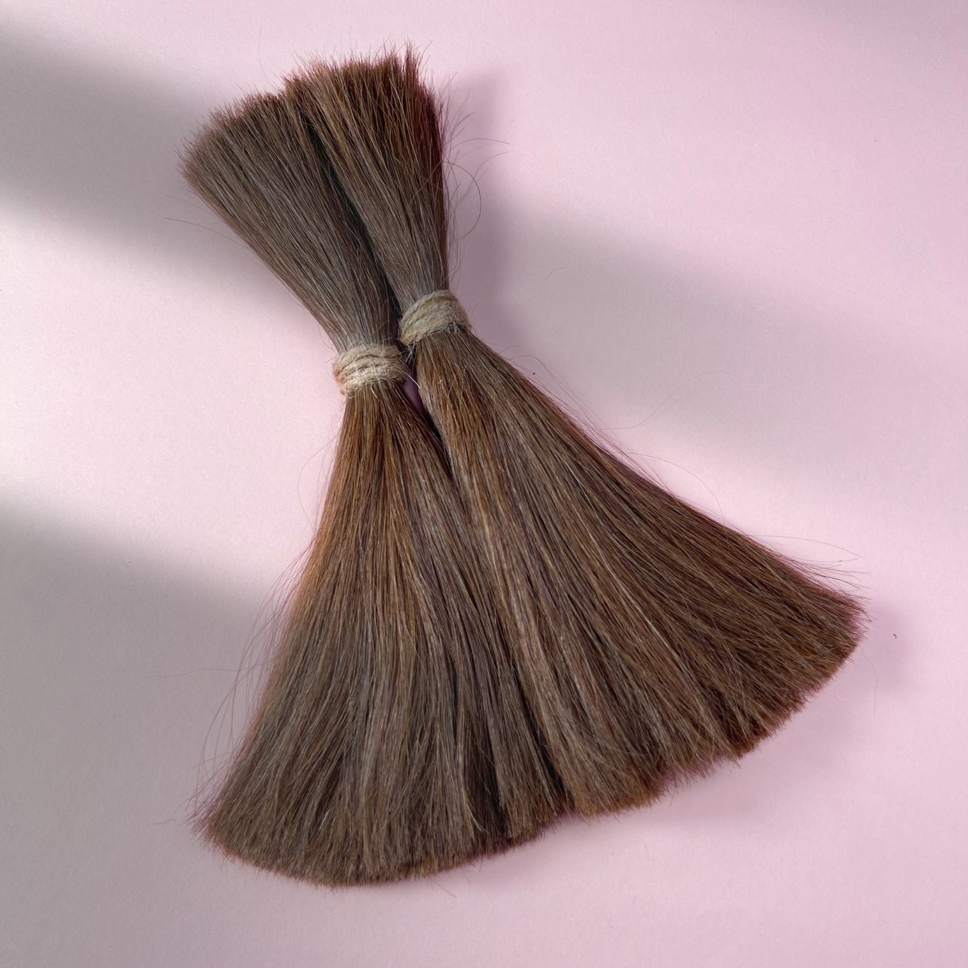 Full view of straight human hair in Rich Brown.