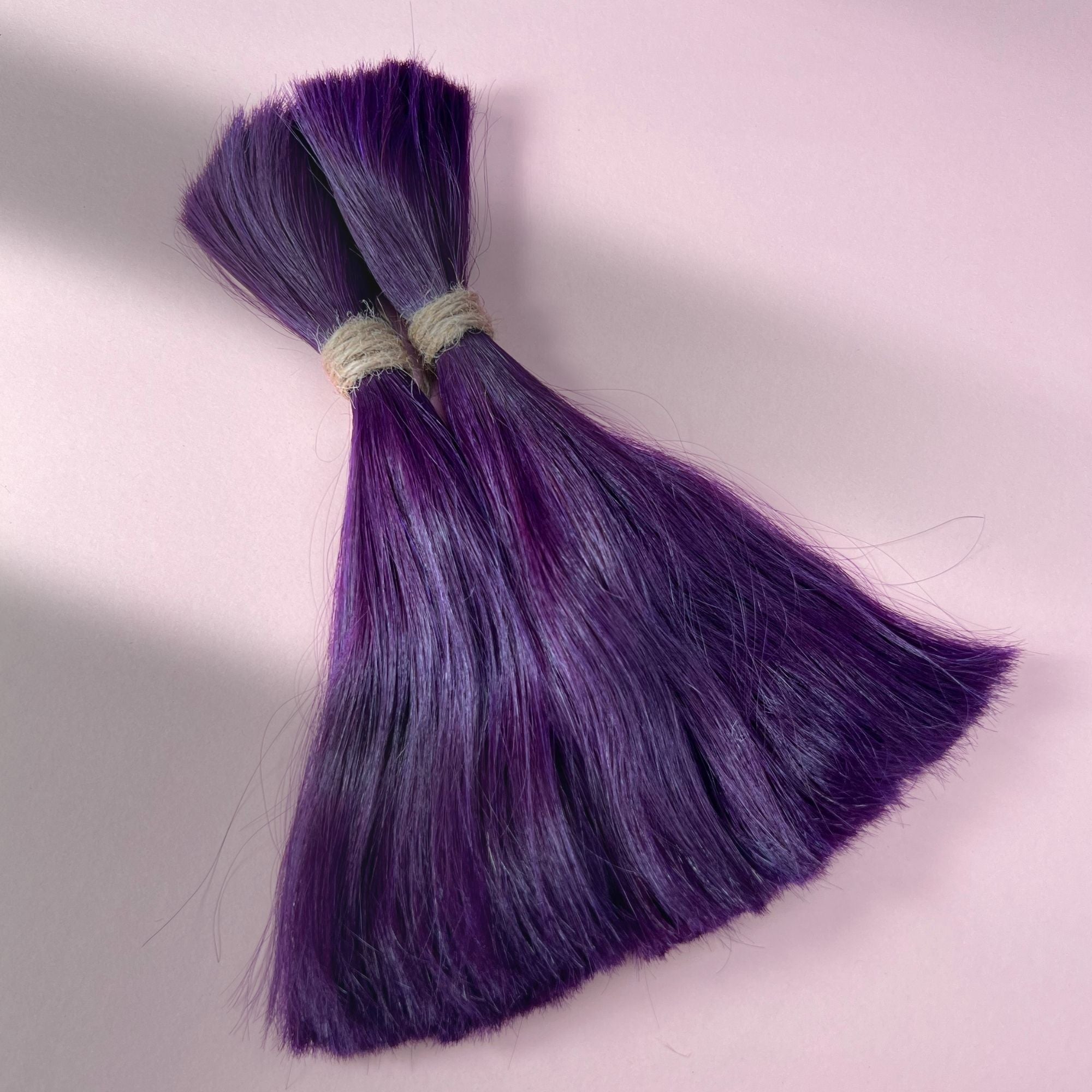 Full view of straight human hair in Electric Violet.