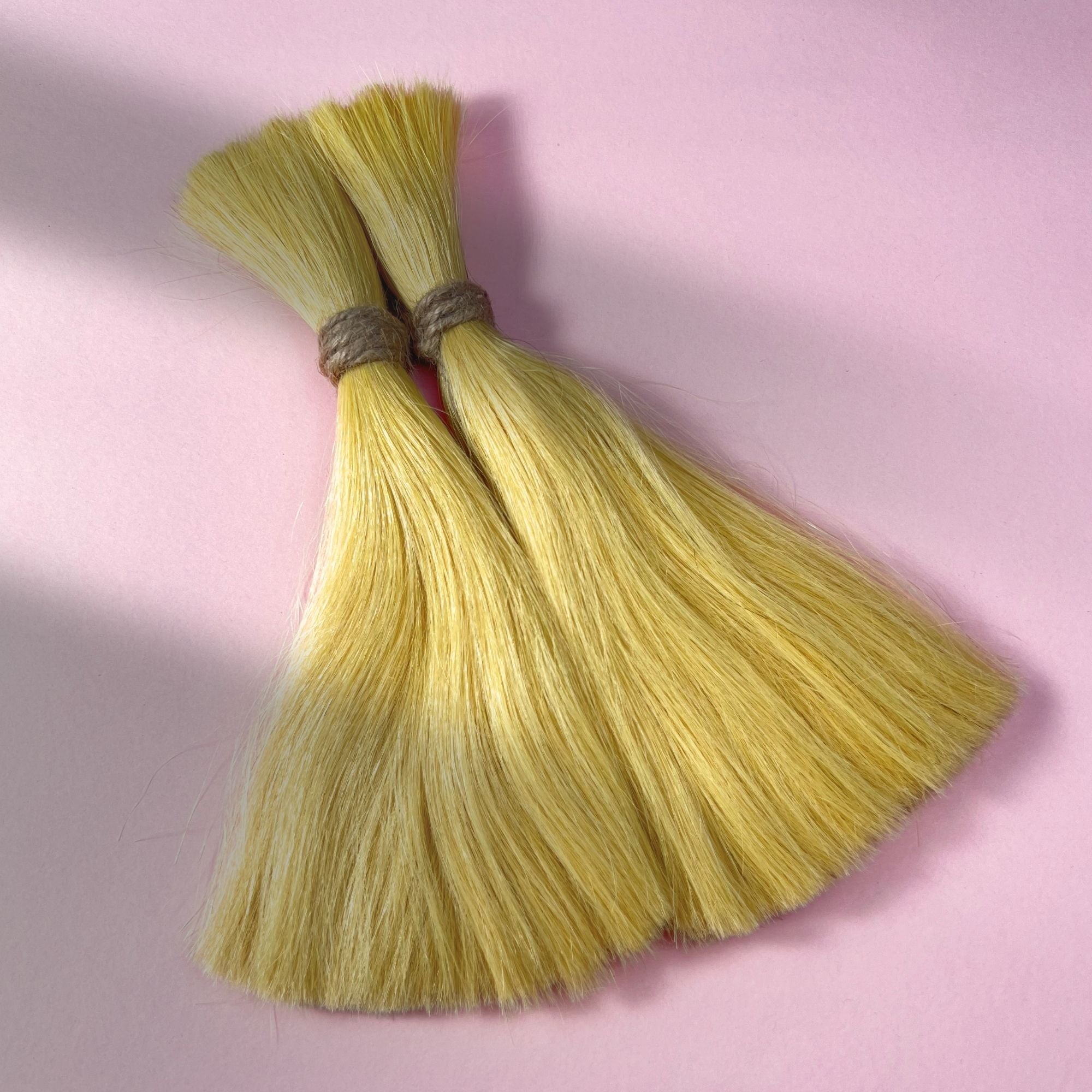 Full view of straight human hair in Soft Ochre.