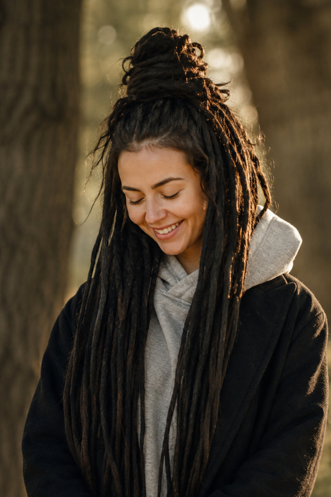 Female model wearing very long dark Straight Loc Extensions by Dreadradar