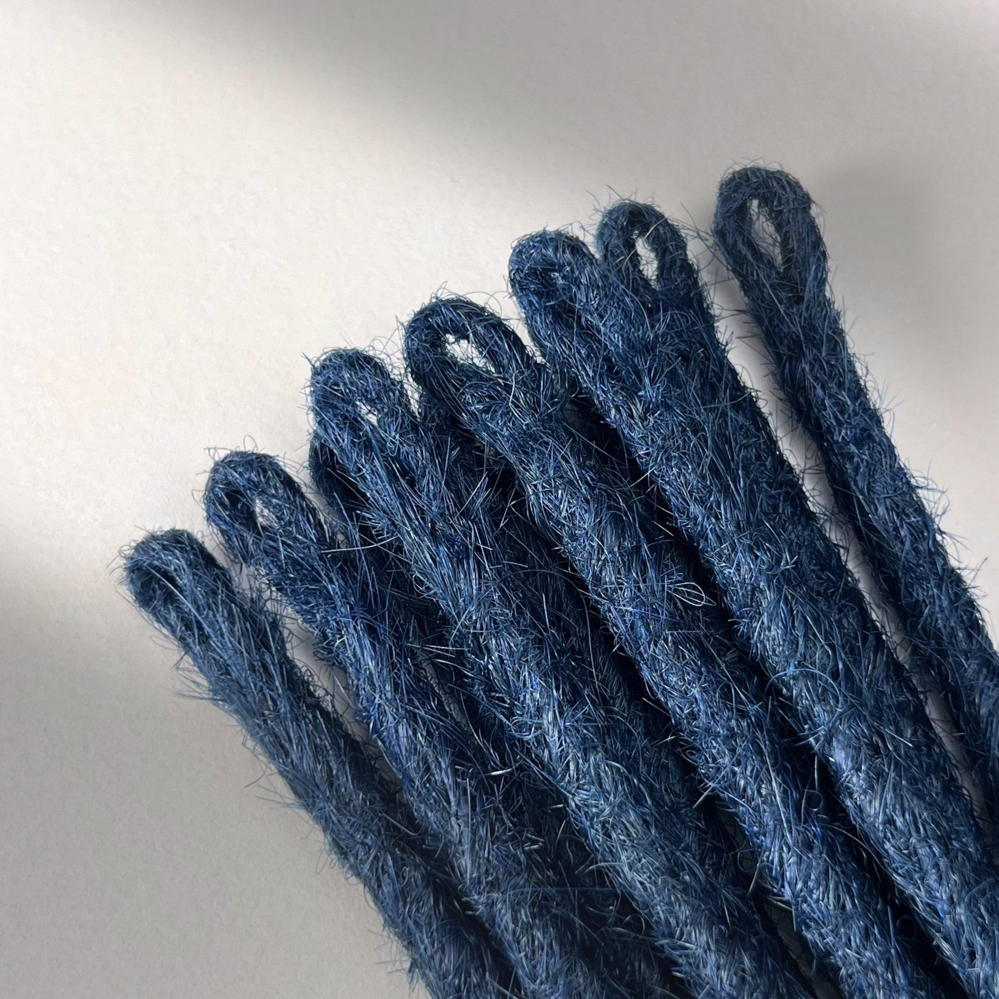 Loop detail of temporary single-ended straight loc extensions in Midnight Blue.