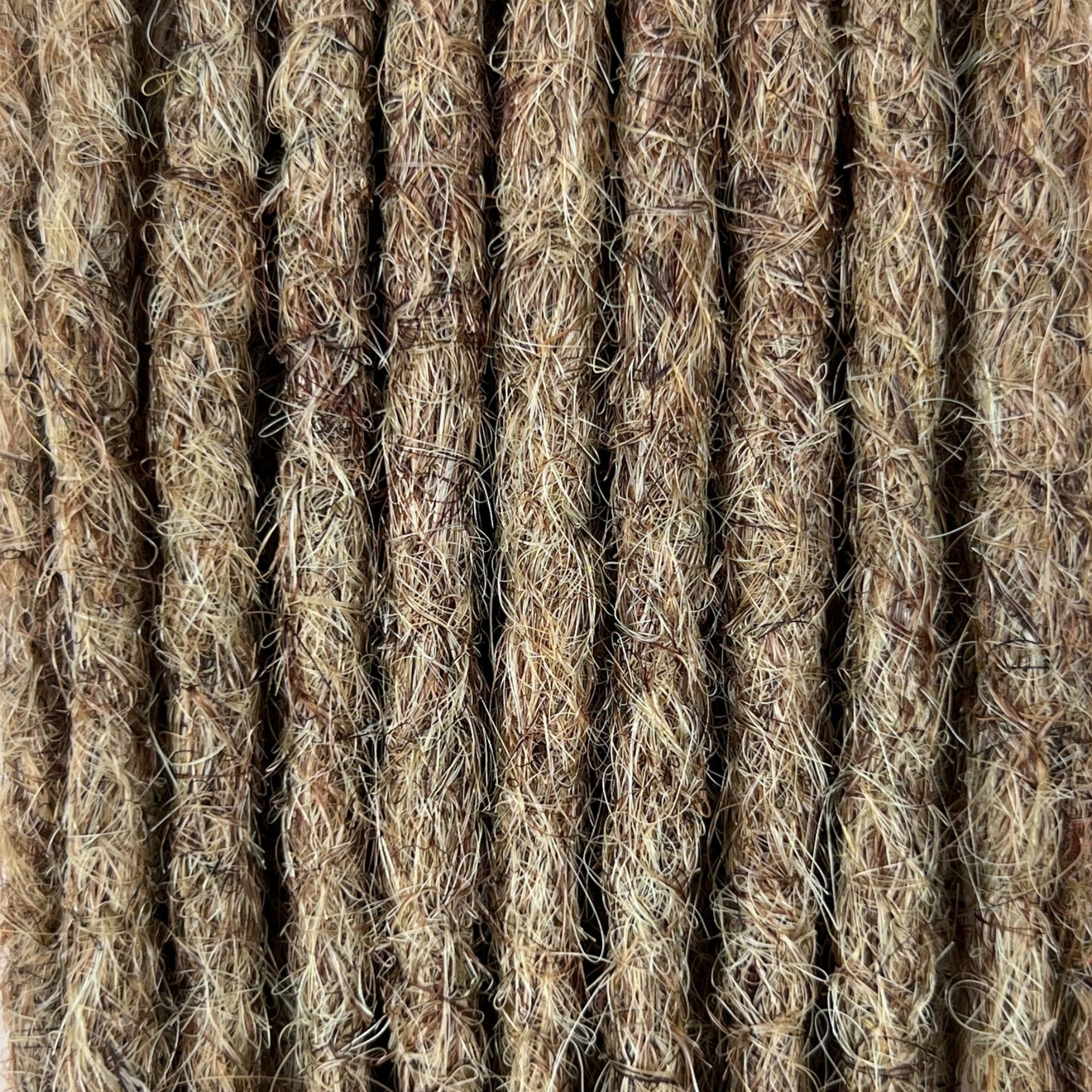 Close-up of straight loc extensions in Sandy Blonde, showing the texture and color.