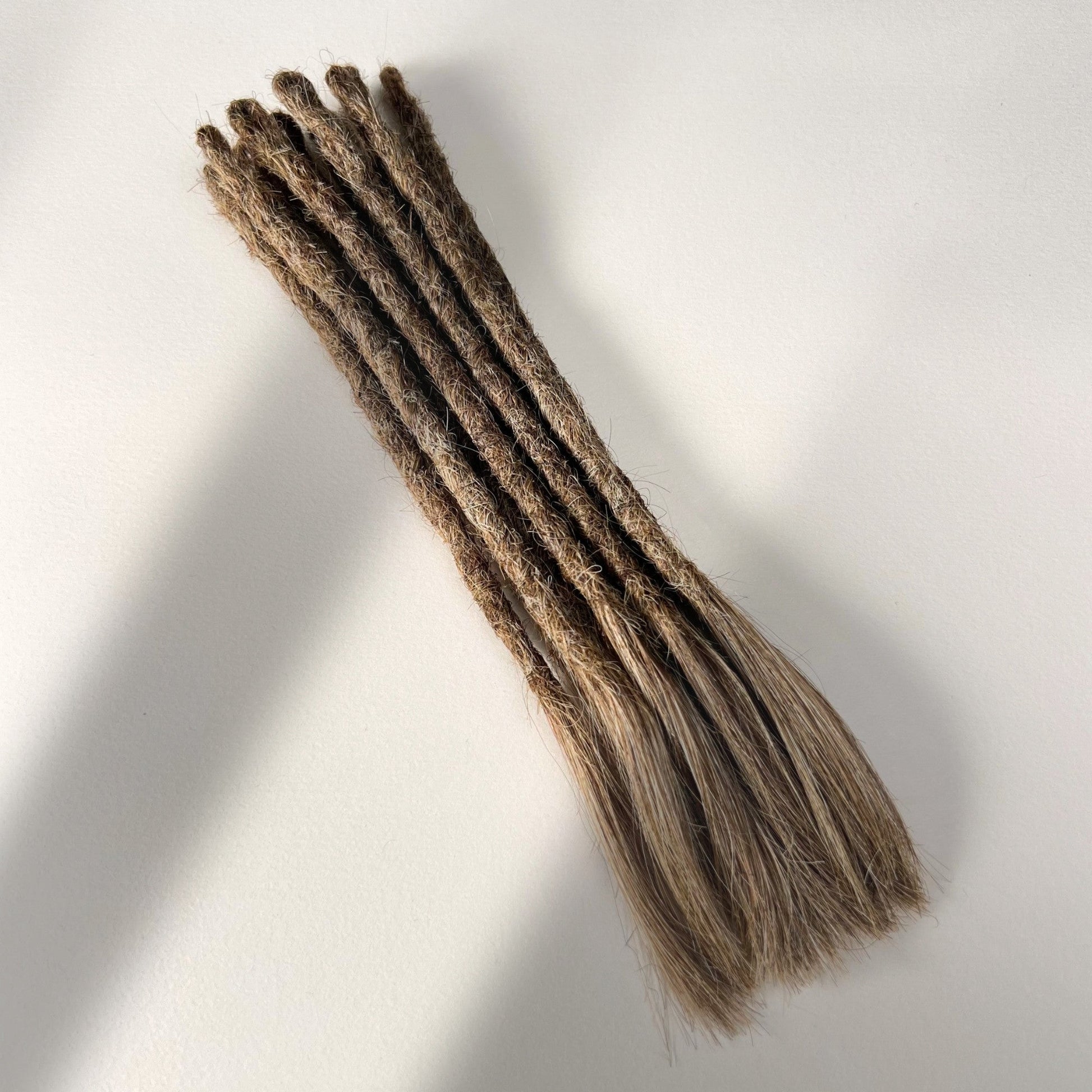 Full view of temporary single-ended straight loc extensions with open ends in Light Beige Blonde.