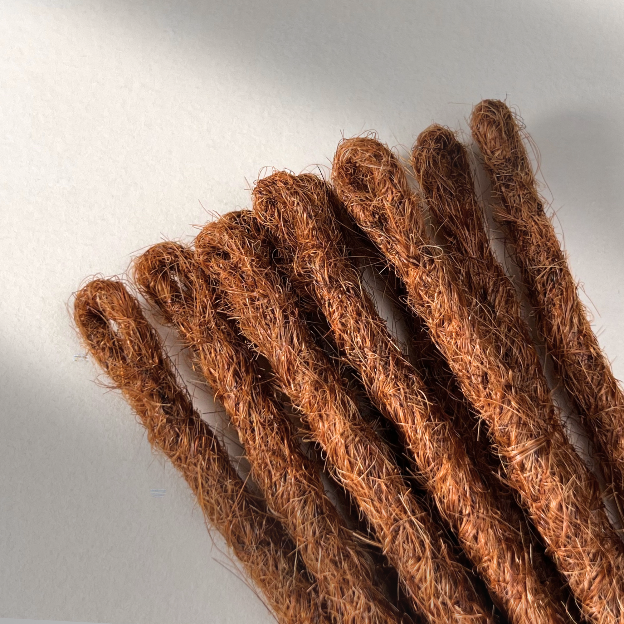 Loop detail of temporary single-ended straight loc extensions in Burnt Sienna Copper.