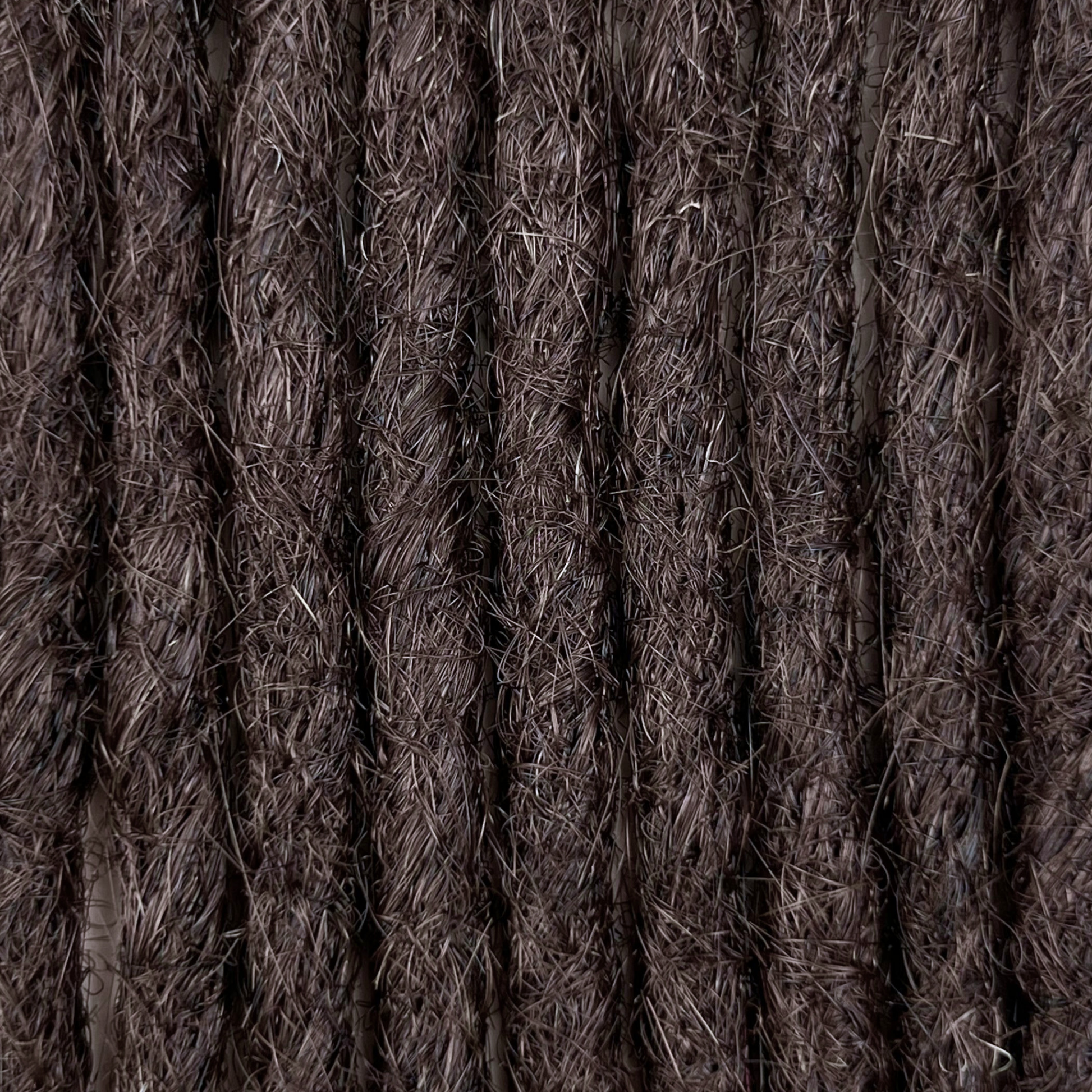 Close-up of straight loc extensions in Warm Caramel Brown, showing the texture and color.