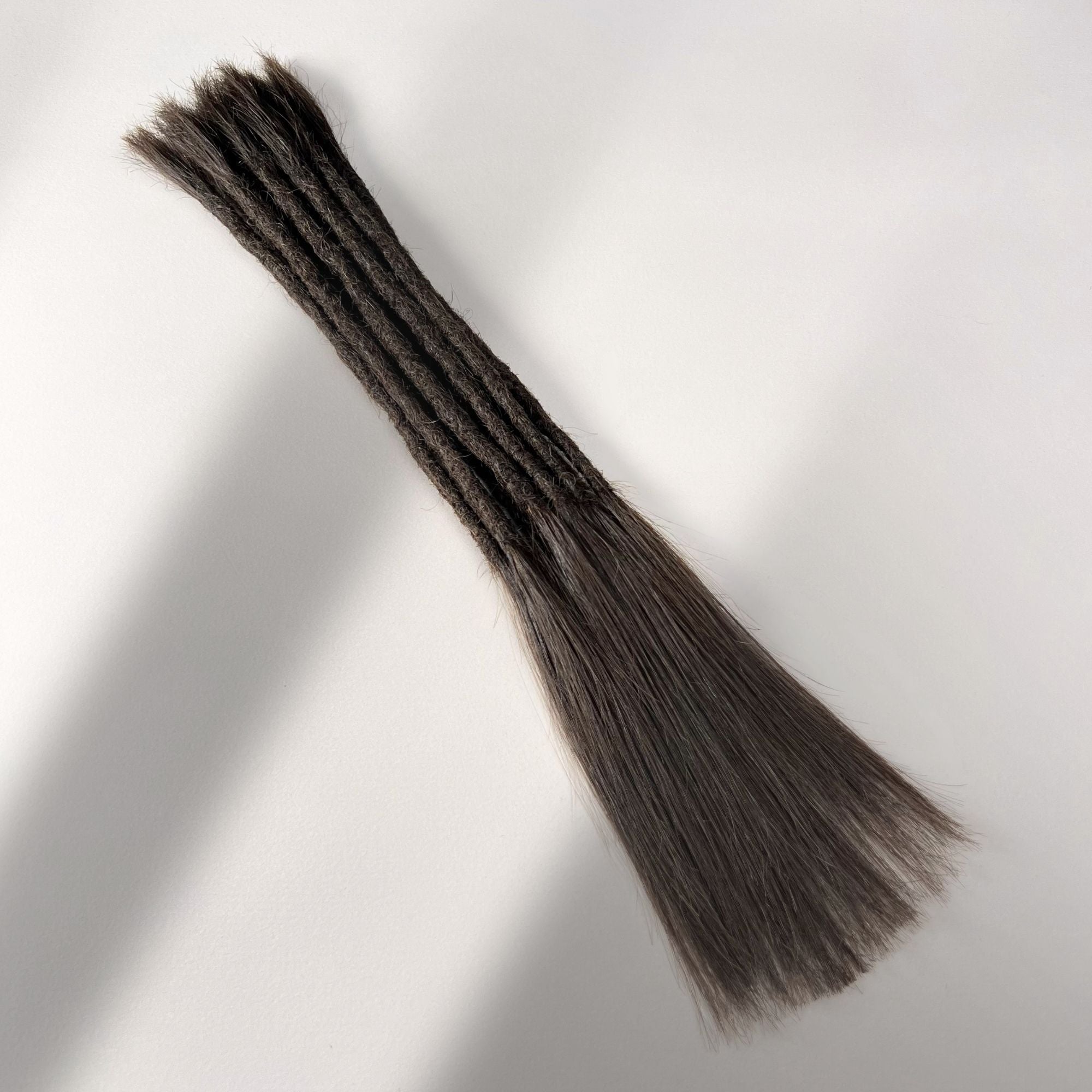 Full view of permanent straight loc extensions with long loose ends in Dark Wenge Brown.