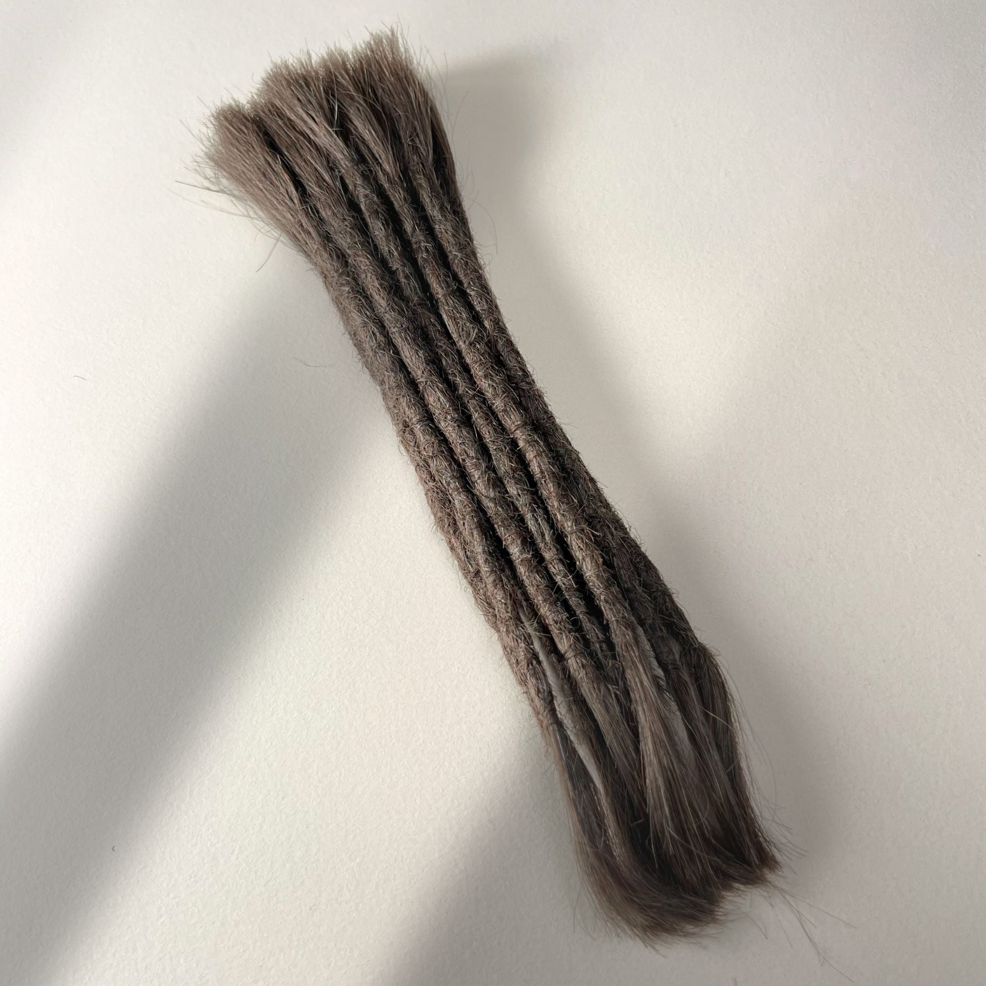 Full view of permanent straight loc extensions with open ends in Dark Wenge Brown.