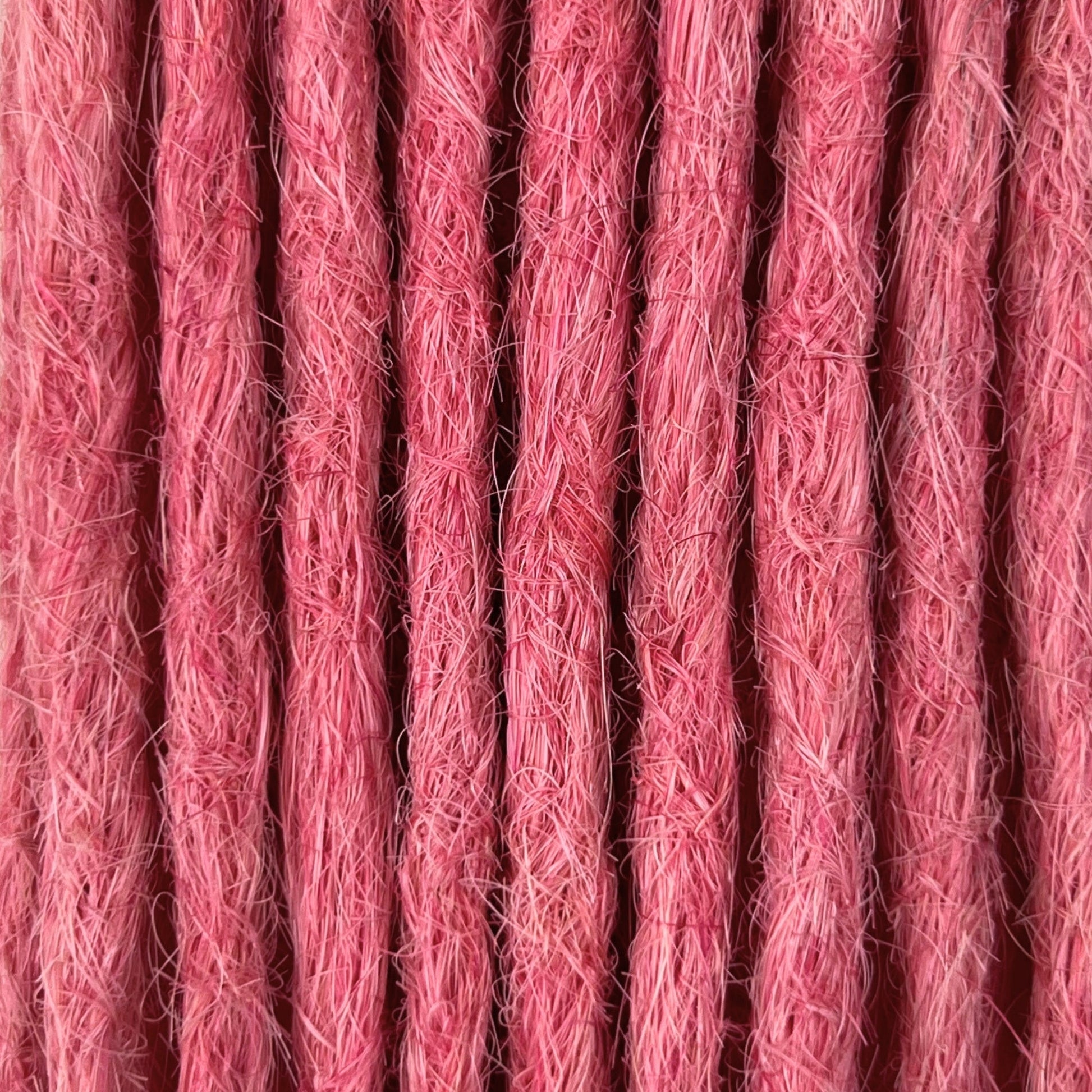 Close-up of straight loc extensions in Bubblegum Pink, showing the texture and color.