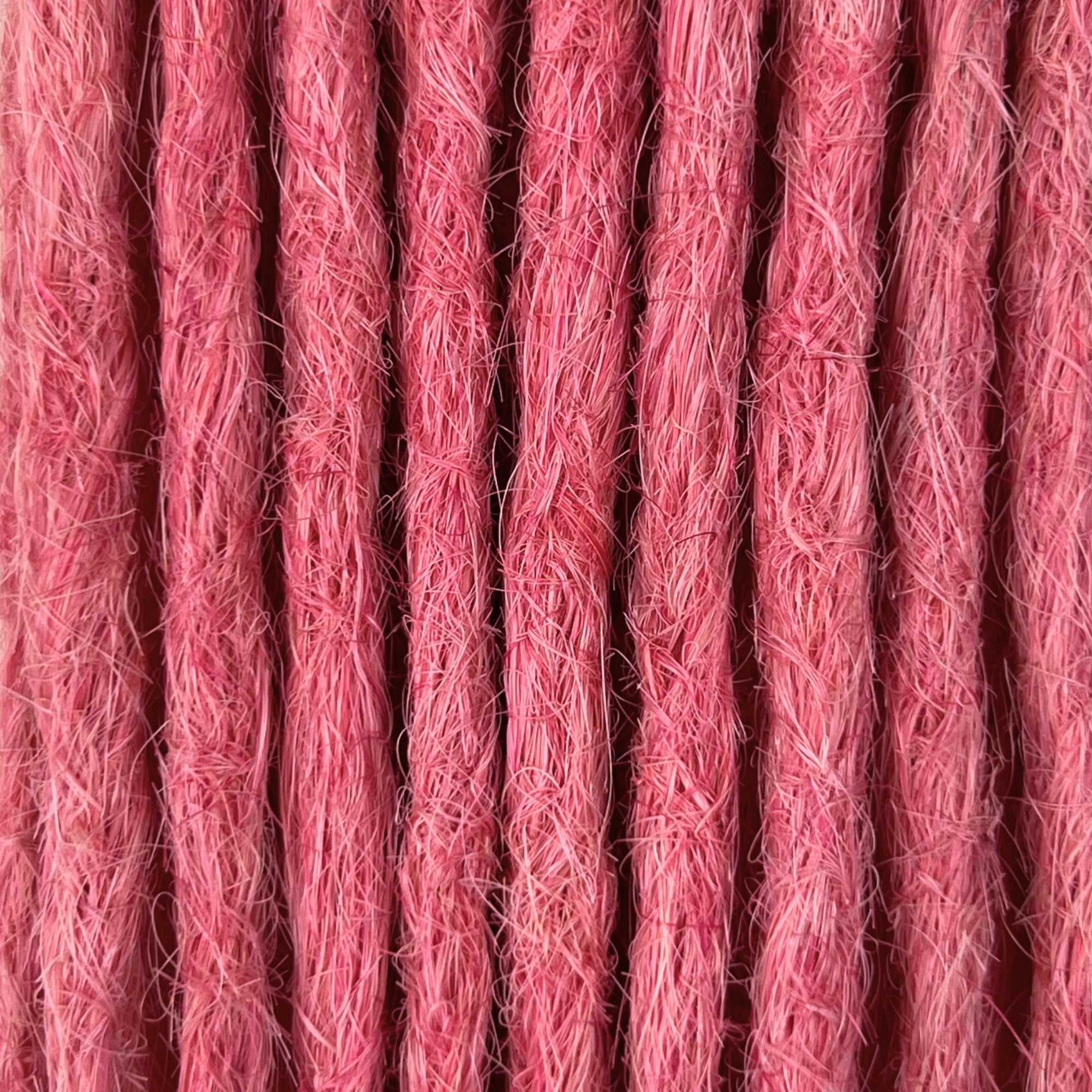 Close-up of straight loc extensions in Bubblegum Pink, showing the texture and color.